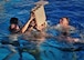 Members from 26th Special Tactics Squadron rally together to empty a five gallon jug while treading water during the pool component of a Monster Mash Aug. 6, 2014 at Cannon Air Force Base, N.M. The Air Commandos were memorializing the sacrifices of those who lost their lives aboard Extortion 17. (U.S. Air Force photo/Staff Sgt. Alexxis Pons Abascal)  