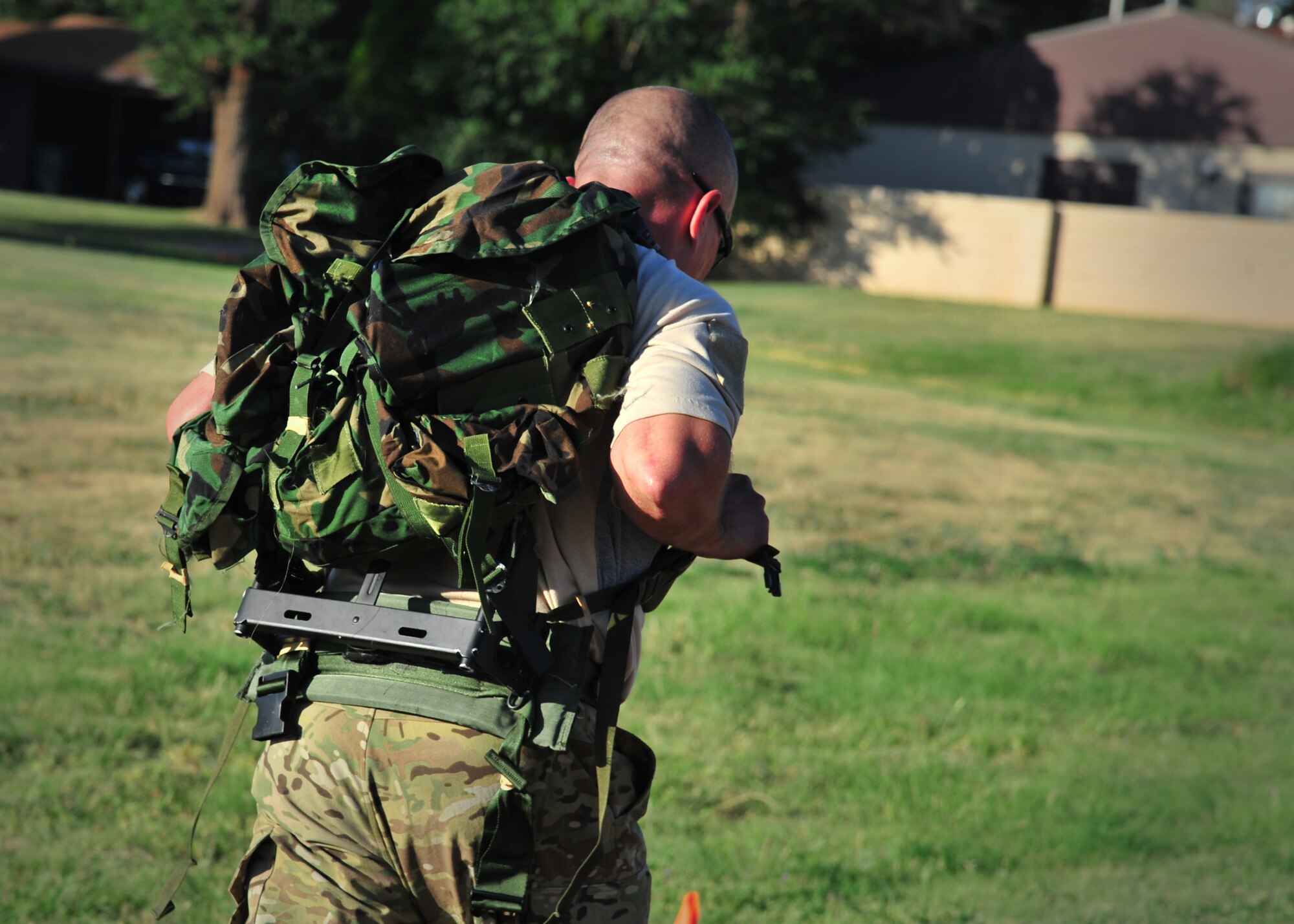 A member from 26th Special Tactics Squadron endures the additional weight of his ruck during a Monster Mash Aug. 6, 2014 at Cannon Air Force Base, N.M. The Air Commandos participating in the event were memorializing the sacrifices of those who lost their lives aboard Extortion 17. (U.S. Air Force photo/Staff Sgt. Alexxis Pons Abascal)