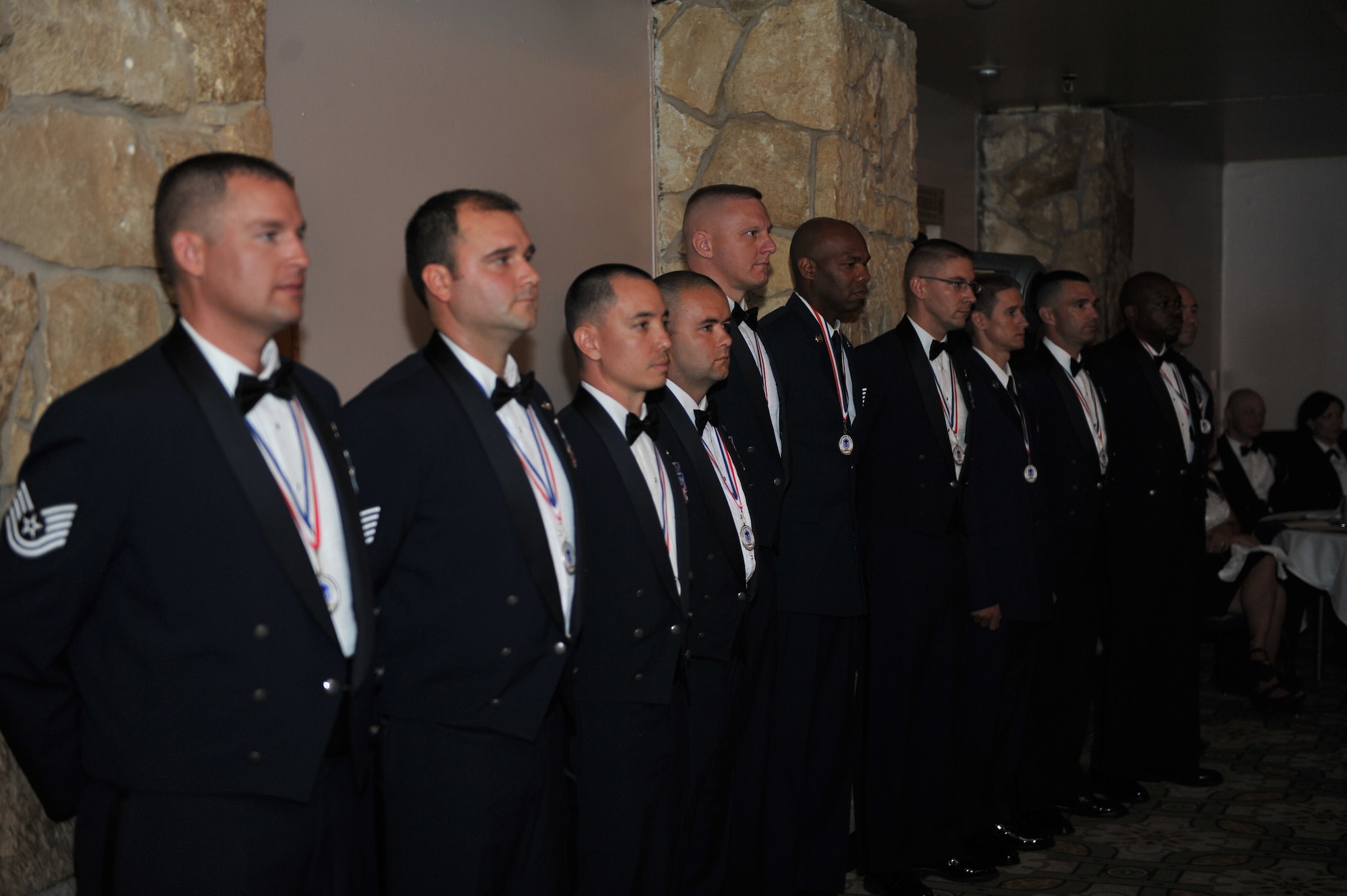ALTUS AIR FORCE BASE, Okla. – Inductees form a line before receiving their plaques at the Senior NCO Induction Ceremony inside Club Altus Aug. 8, 2014. The ceremony honors the future senior NCOs and is a long-standing tradition that signifies the inductees have reached the top tier of the enlisted core. (U.S. Air Force photo by Senior Airman Dillon Davis/Released)