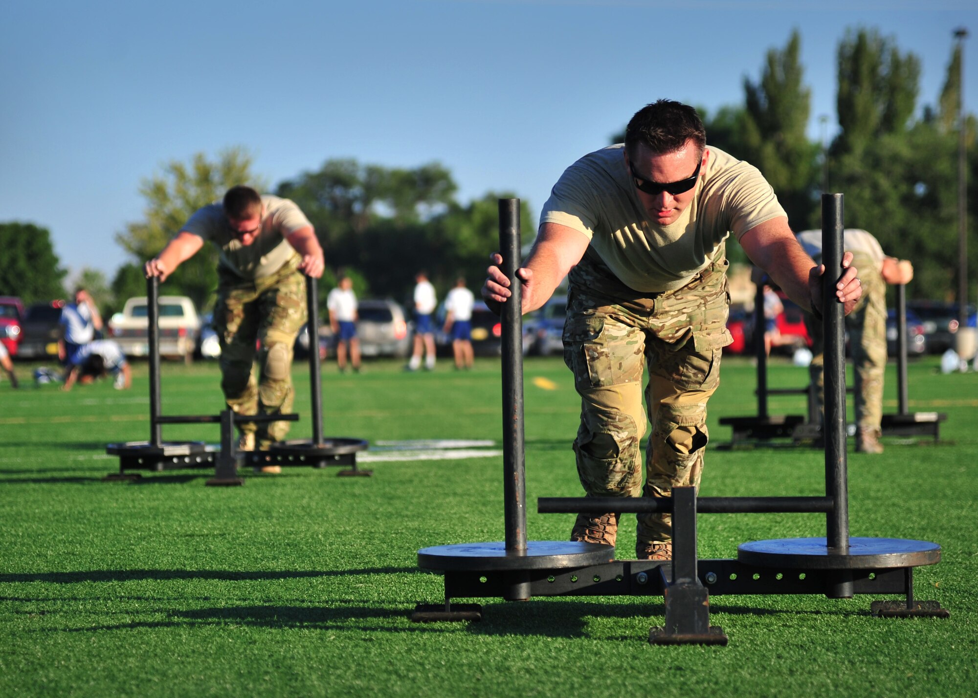 Members from 26th Special Tactics Squadron race to push sleighs across the fitness center track Aug. 6, 2014 at Cannon Air Force Base, N.M. The Air Commandos were memorializing the sacrifices of those who lost their lives aboard Extortion 17 during a Monster Mash organized by an airman in the squadron. (U.S. Air Force photo/Staff Sgt. Alexxis Pons Abascal) 
