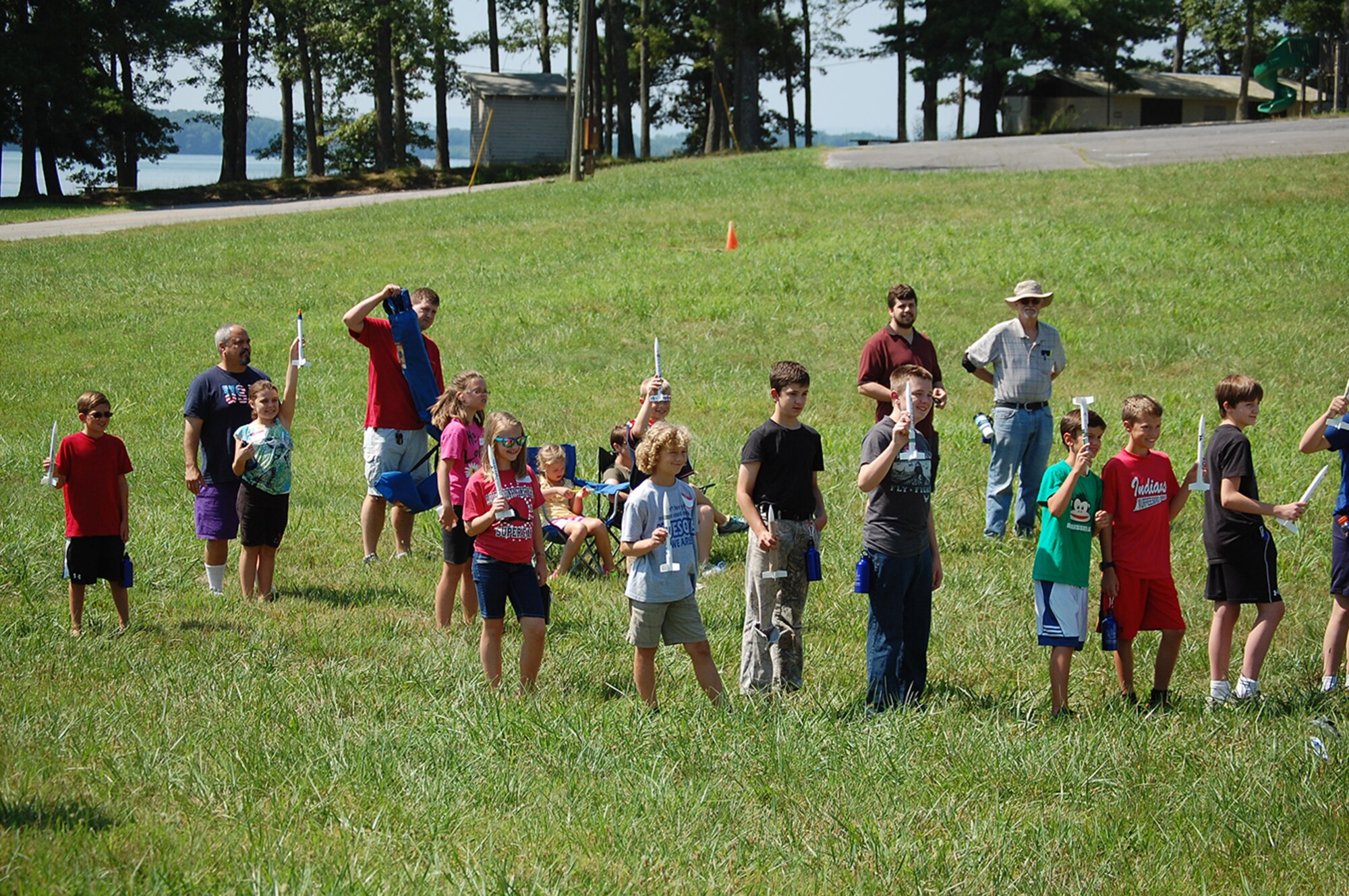 Students hold up the rockets they built as part of the Reach for the Stars rocket launch competition held at Arnold Engineering Development Complex’s Gossick Leadership Center. 
