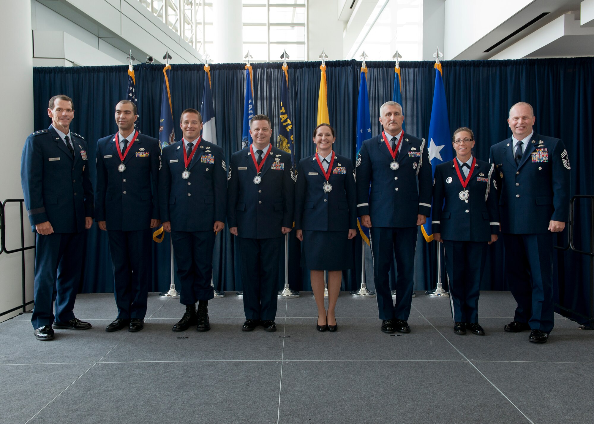 Lieutenant Gen. Stanley E. Clarke III, director of the Air National Guard (left) and Chief Master Sgt. James W. Hotaling, the command chief master sergeant of the ANG (far right), stand with the ANG Outstanding Airmen of the Year during an All Call event at Joint Base Andrews, Maryland August 7, 2014. The OAY winners are (left to right) Senior Airman Christian Goldsmith, Airman of the Year, Tech. Sgt. Doug Matthews, Non-Commissioned Officer of the Year, Master Sgt. Joseph G. Ashwood, Senior Non-Commissioned Officer of the Year, Master Sgt. Linda Schwartzlow, First Sergeant of the Year, Master Sgt. David Coker, Honor Guard Program Manager of the Year, and Tech. Sgt. Amy Ough, Honor Guard Member of the Year. (Air National Guard photo by Master. Sgt. Marvin R. Preston/Released)