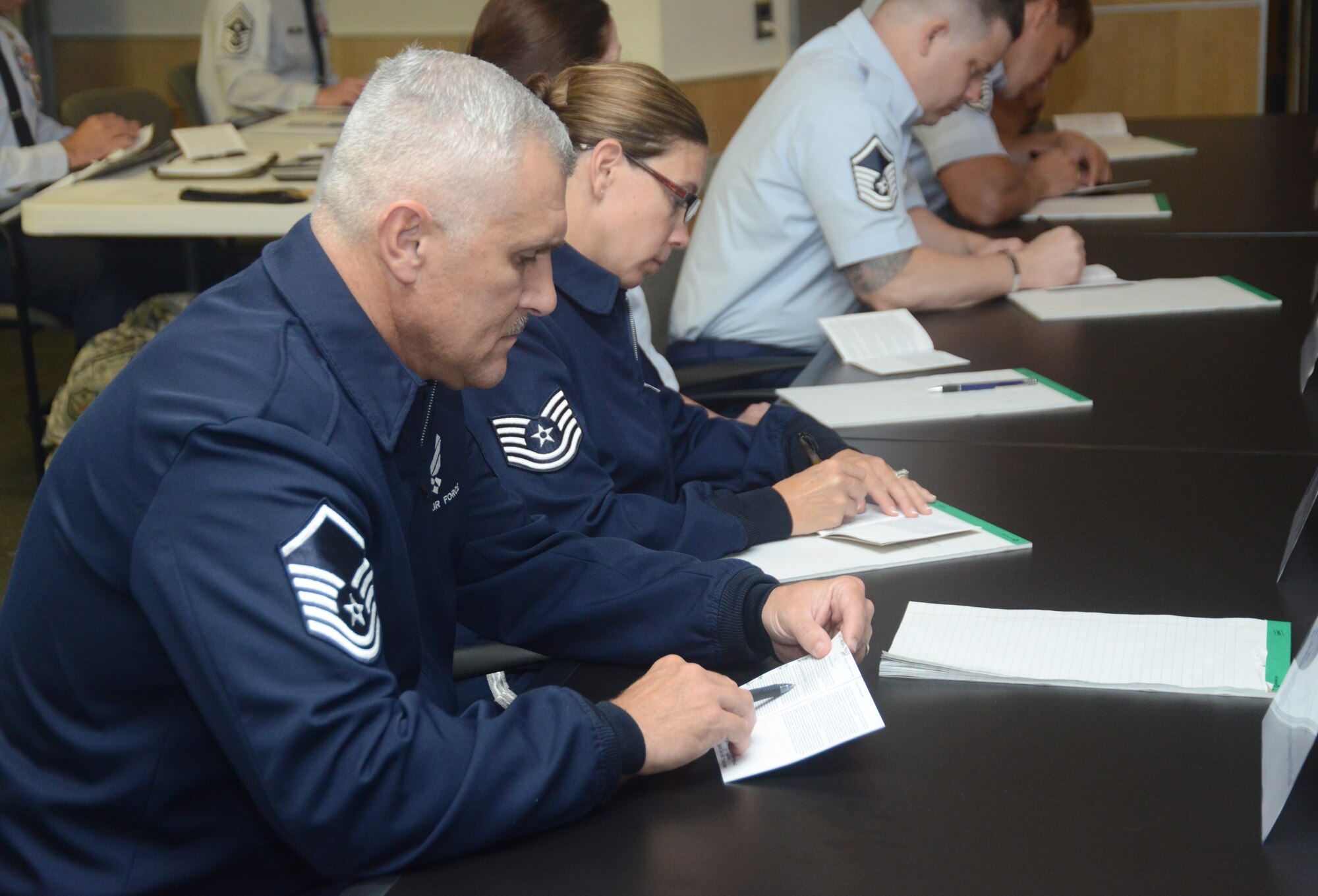 Master Sgt. David Coker, the ANG's 2014 Outstanding Honor Guard Program Manager of the Year, references AFI 36-2618, also known as the "little brown book" during a discussion on the enlisted force structure during the Chiefs' Executive Course held at the Air National Guard Readiness Center on Joint Base Andrews, Md., Aug. 4, 2014. The Outstanding Airmen of the Year winners had the opportunity to sit i on the course as part of Focus on the Force week. (U.S. Air National Guard photo by Senior Airman John E. Hillier/Released)