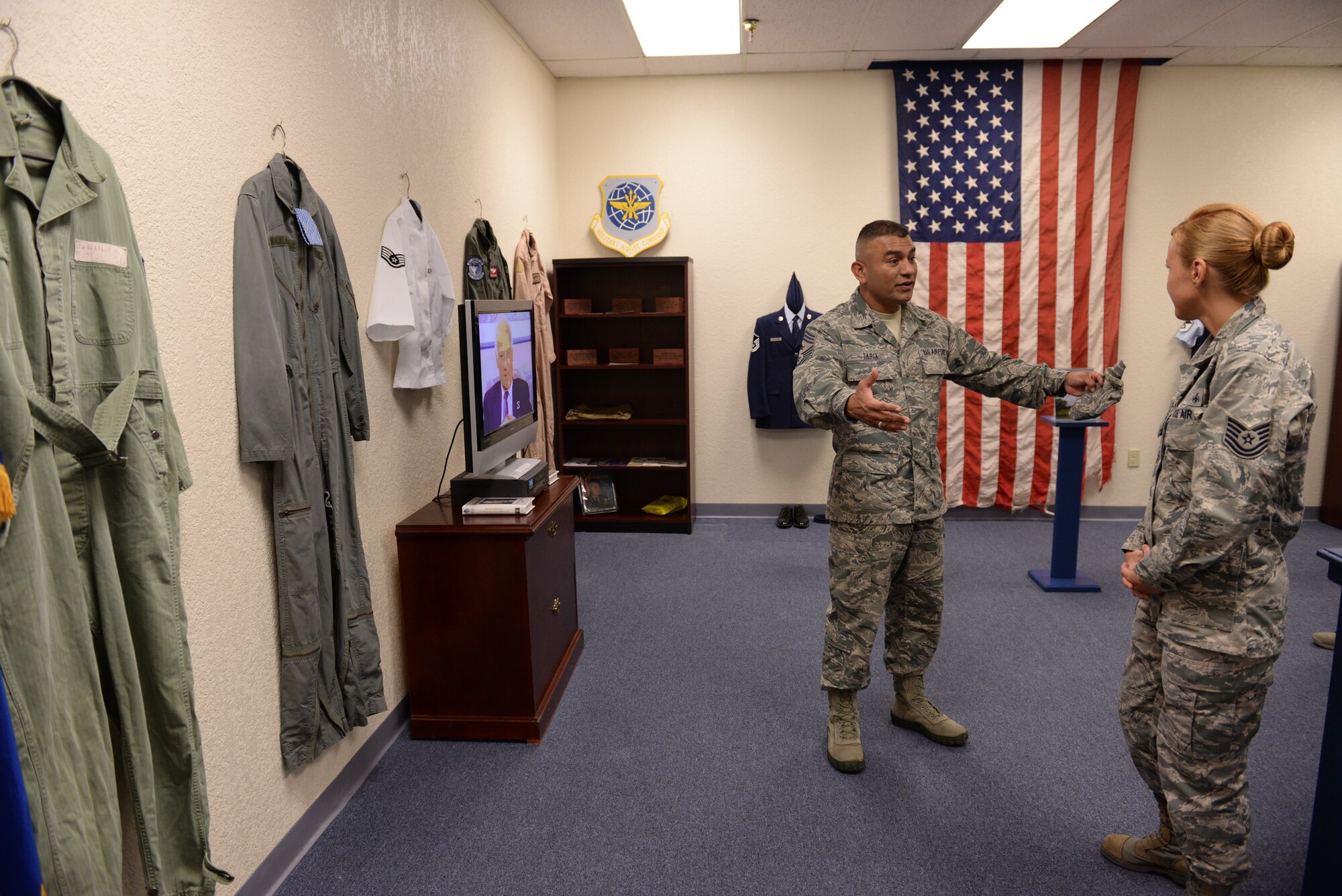 ALTUS AIR FORCE BASE, Okla. – U.S. Air Force Chief Master Sgt. Gerardo Tapia, command chief of Air Education and Training Command, asks questions about heritage to U.S. Air Force Tech. Sgt. Christy Baumgardner, 97th Force Support Squadron Airman Leadership School instructor, inside the ALS Heritage Room Aug. 8, 2014. The school hosts students from Altus AFB and Vance Air Force Base, which is located about three hours northeast of Altus. (U.S. Air Force photo by Staff Sgt. Nathanael Callon/Released) 