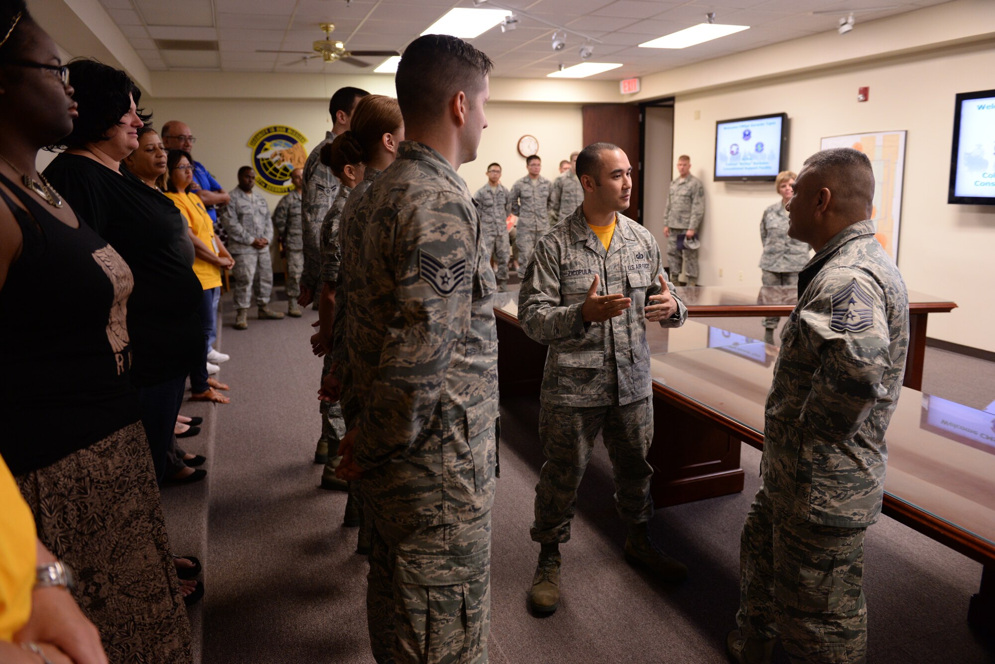 ALTUS AIR FORCE BASE, Okla. – U.S. Air Force Tech. Sgt. Christopher Zicopula, 97th Comptroller Squadron budget analyst, explains the squadron’s unique customer service capabilities to U.S. Air Force Chief Master Sgt. Gerardo Tapia, command chief of Air Education and Training Command, during Tapia’s visit to the 97th Air Mobility Wing Aug. 8, 2014. The comptroller squadron accommodates incoming Airmen through personal appointments, where a technician assists the member in filing travel vouchers and other paperwork in a one-on-one setting. (U.S. Air Force photo by Staff Sgt. Nathanael Callon/Released) 