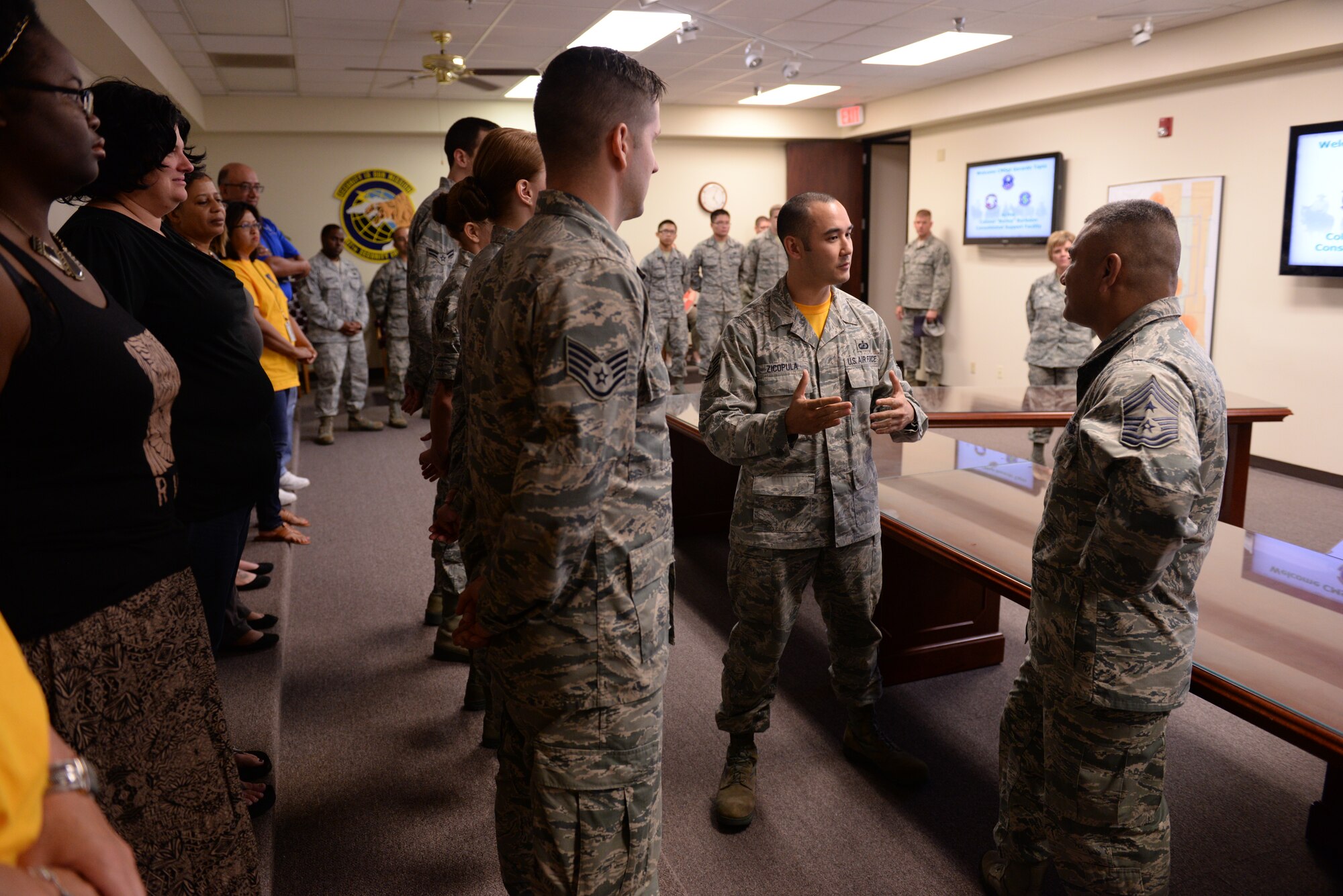 ALTUS AIR FORCE BASE, Okla. – U.S. Air Force Tech. Sgt. Christopher Zicopula, 97th Comptroller Squadron budget analyst, explains the squadron’s unique customer service capabilities to U.S. Air Force Chief Master Sgt. Gerardo Tapia, command chief of Air Education and Training Command, during Tapia’s visit to the 97th Air Mobility Wing Aug. 8, 2014. The comptroller squadron accommodates incoming Airmen through personal appointments, where a technician assists the member in filing travel vouchers and other paperwork in a one-on-one setting. (U.S. Air Force photo by Staff Sgt. Nathanael Callon/Released) 