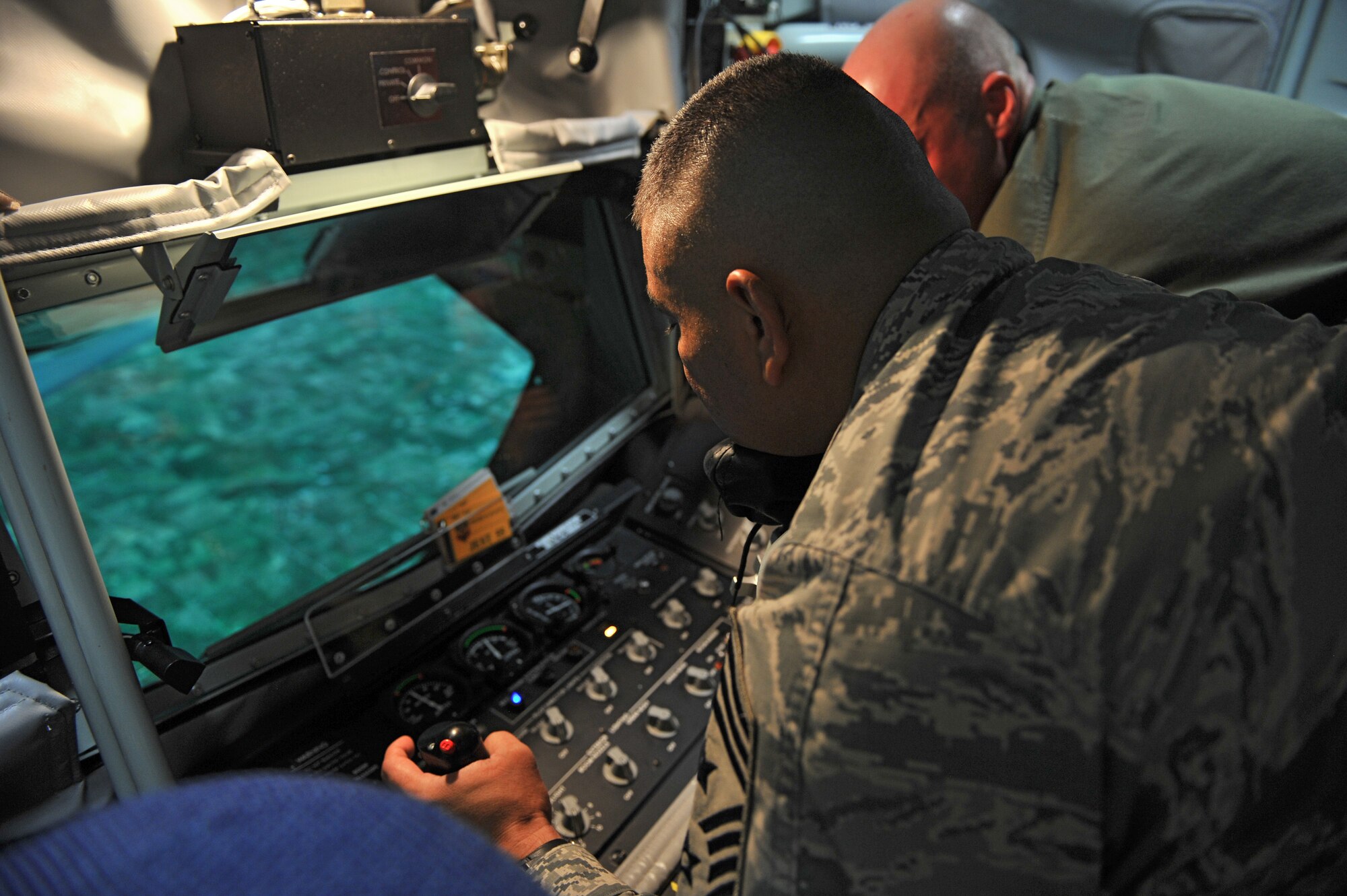 ALTUS AIR FORCE BASE, Okla. – U.S. Air Force Chief Master Sgt. Gerardo Tapia, command chief of Air Education and Training Command, simulates in-flight refueling from a KC-135 Stratotanker during a visit to the Boom Operator Weapons System Training Simulator Aug. 7, 2014. Tapia was able to get a hands-on look at the 97th Air Mobility Wing’s training mission and its contribution to meeting future warfighter needs. (U.S. Air Force photo by Senior Airman Dillon Davis/Released)