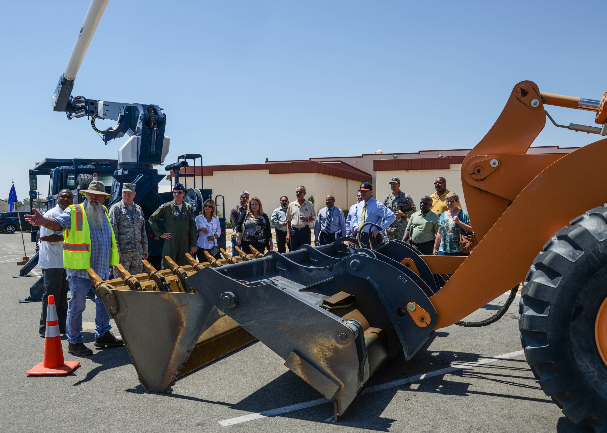 Mike Anderson (yellow vest), 412th Civil Engineering pavement supervisor, taught the new group commanders about the typical work equipment used by CE such as a bucket truck, front-end loader and back hoe. (U.S. Air Force photo by Rebecca Amber) 