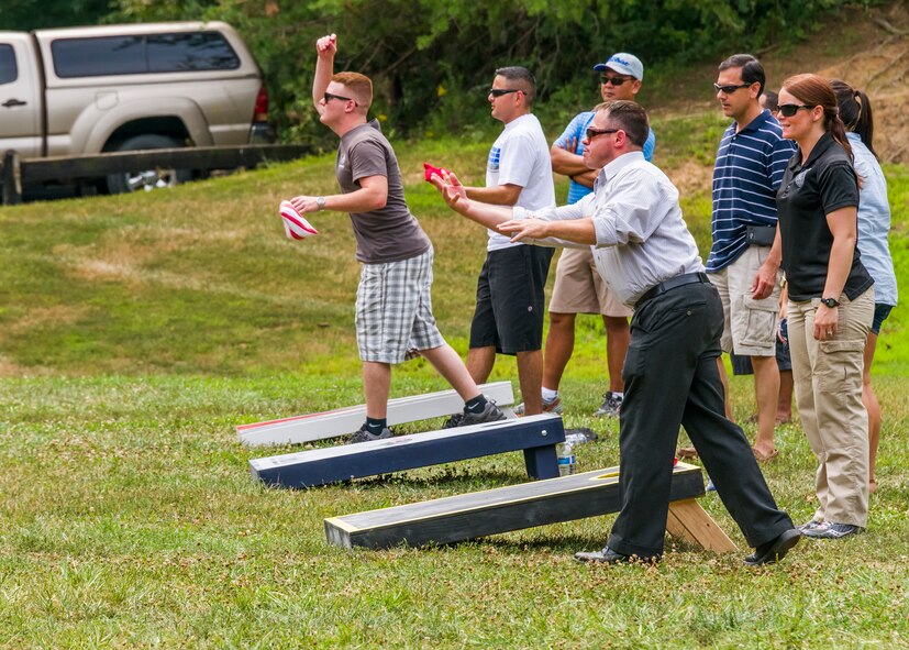 OSI members play corn hole. (photo by Mike Hastings)