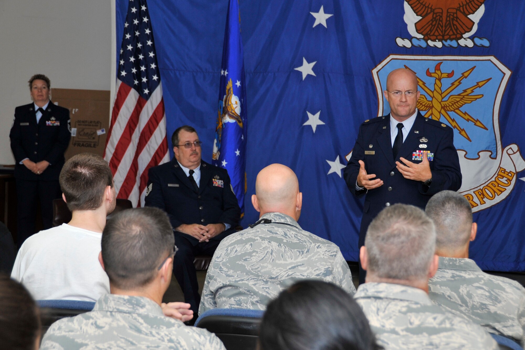 U.S. Air Force Major William Magee, commander, 44th Maintenance Squadron, Tyndall Air Force Base, Fla., speaks to family and friends of Tech. Sgt. Brian Sharp during a retirement ceremony at Barksdale Air Force Base, La., Aug. 2, 2014. Sharp retired with more than 27 years of service. (U.S. Air force photo by Master Sgt. Jeff Walston/Released)