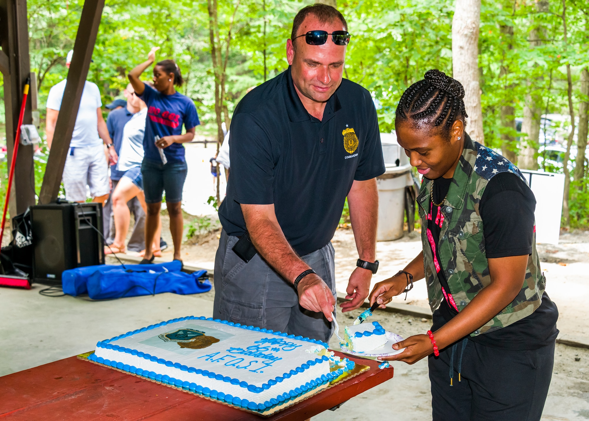 Brig. Gen. Keith Givens, OSI commander, and the youngest OSI member present, Senior Airman LateshaOliver, cut the Birthday cake. (photo by Mike Hastings)