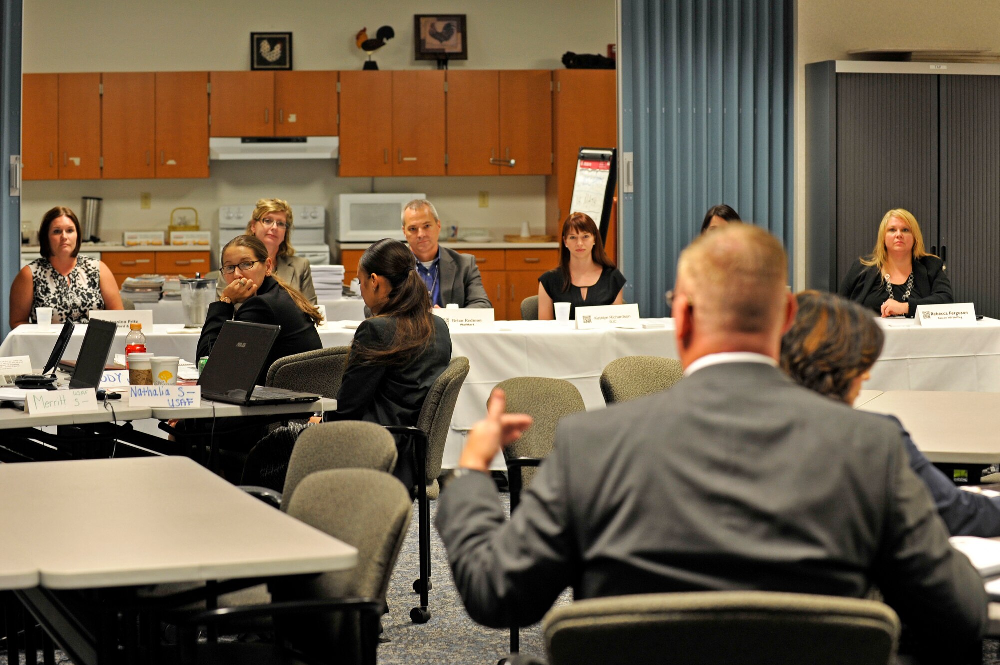A service member asks a question to a panel of employers during a Transition Assistance Program class at Scott Air Force Base, Ill., Aug. 6, 2014. Scott’s TAP class was visited by a team from the Transition to Veterans Program Office that is working on collecting best techniques for the class. The TAP classes are held at the Airman and Family Readiness Center. TAP has recently been revamped into a five-day course, including how to prepare for a job in the civilian workplace. (U.S. Air Force photo by Airman 1st Class Erica L. Crossen)