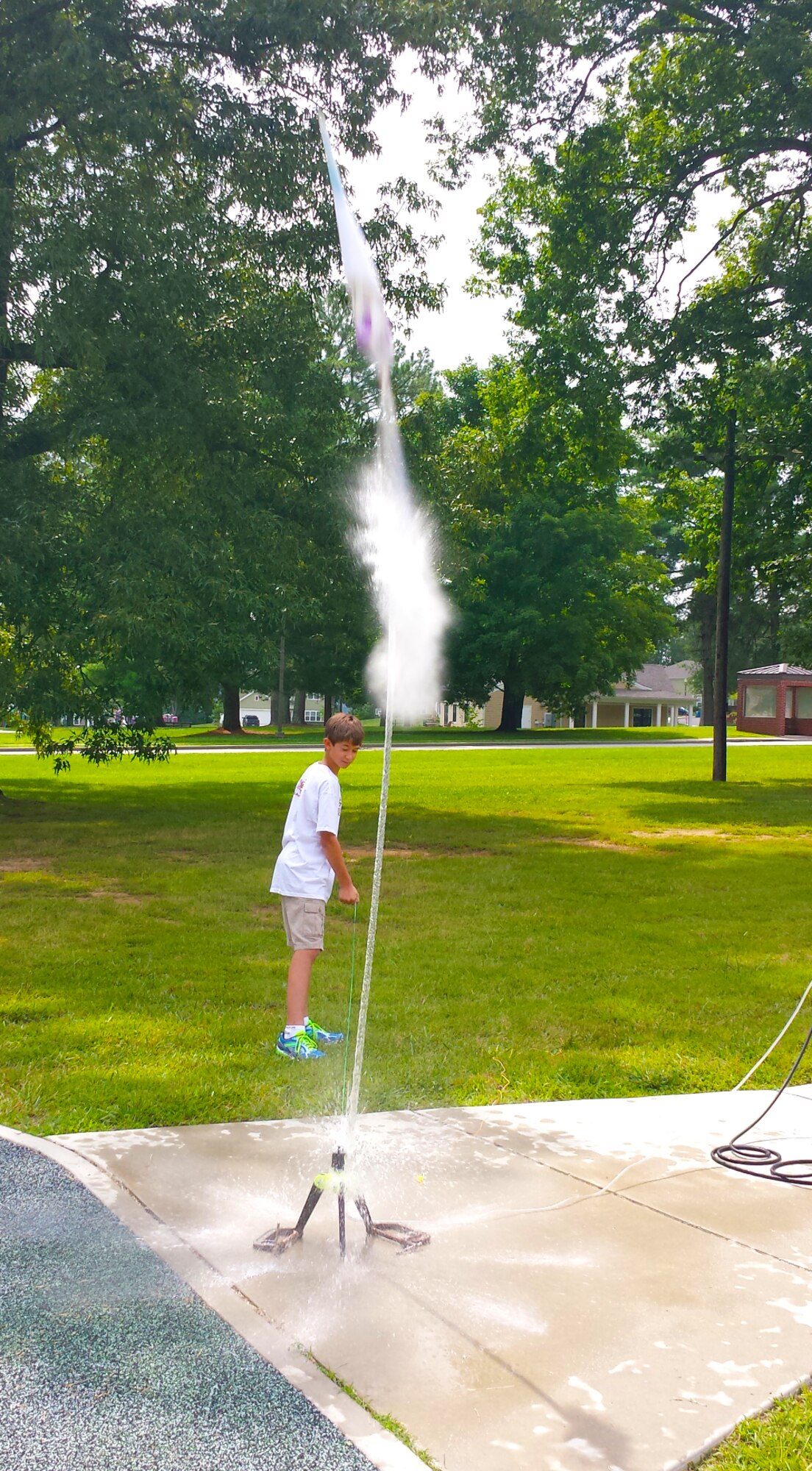 Ben Hurrocks triggers his team’s water-propelled bottle rocket for a launch. The teams designed and built their rockets on the first day of camp. (Photo by Jere Matty)