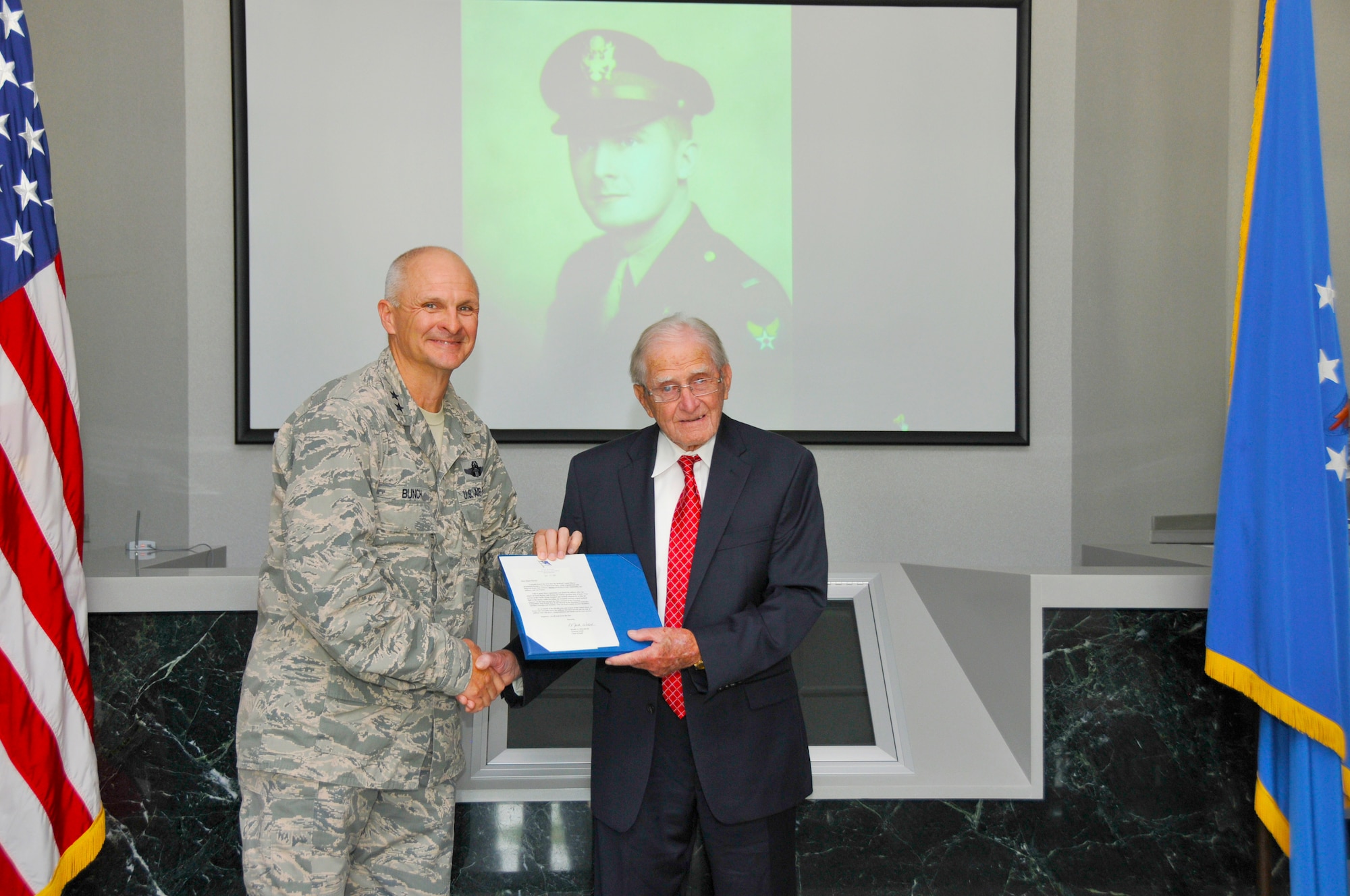 Air Force Test Center Commander Maj. Gen. Arnold W. Bunch Jr. (left) presents the U.S. Air Force Chief of Staff appreciation letter to retired Maj. Ike Farrar, a World War II veteran, on July 22. U.S. Air Force Chief of Staff Gen. Mark Welsh III expressed his appreciation in a letter for Farrar’s contributions to the Air Force. (Photo by Rick Goodfriend)