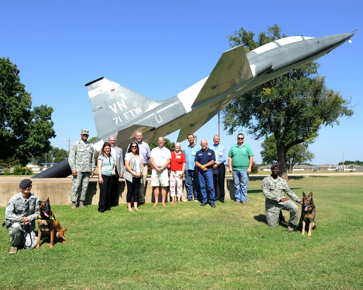 Col. Christopher Daniels (left) stands in front of a static T38 with Vance's Honorary Commanders Aug. 7.  The honorary commanders took a tour of the Airman and Family Readiness Center, the base library, the mobility warehouse, a fire truck, and the military working dogs.  The purpose of Team Vance's Honorary Commander Program is to bring community leaders of varying backgrounds and interests together in partnership with base units. During their tenure, honorary commanders visit each of the three groups at Vance and attend various events with their respective squadron commanders. (U.S. Air Force photo/Staff Sgt. Nancy Falcon)