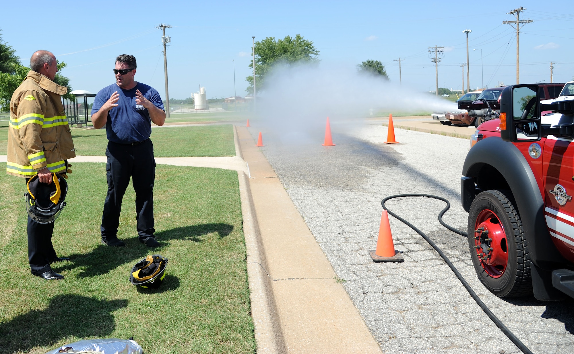 Wesley Felber, a Vance Fire Department fireman, explains the capabilities of the fire engine to David Jamin, the 71st Medical Support Squadron honorary commander, outside Building 288, Aug 7, during the Mission Support Group tour.  The purpose of Team Vance's Honorary Commander Program is to bring community leaders of varying backgrounds and interests together in partnership with base units. During their tenure, honorary commanders visit each of the three groups at Vance and attend various events with their respective squadron commanders. (U.S. Air Force photo/Staff Sgt. Nancy Falcon)