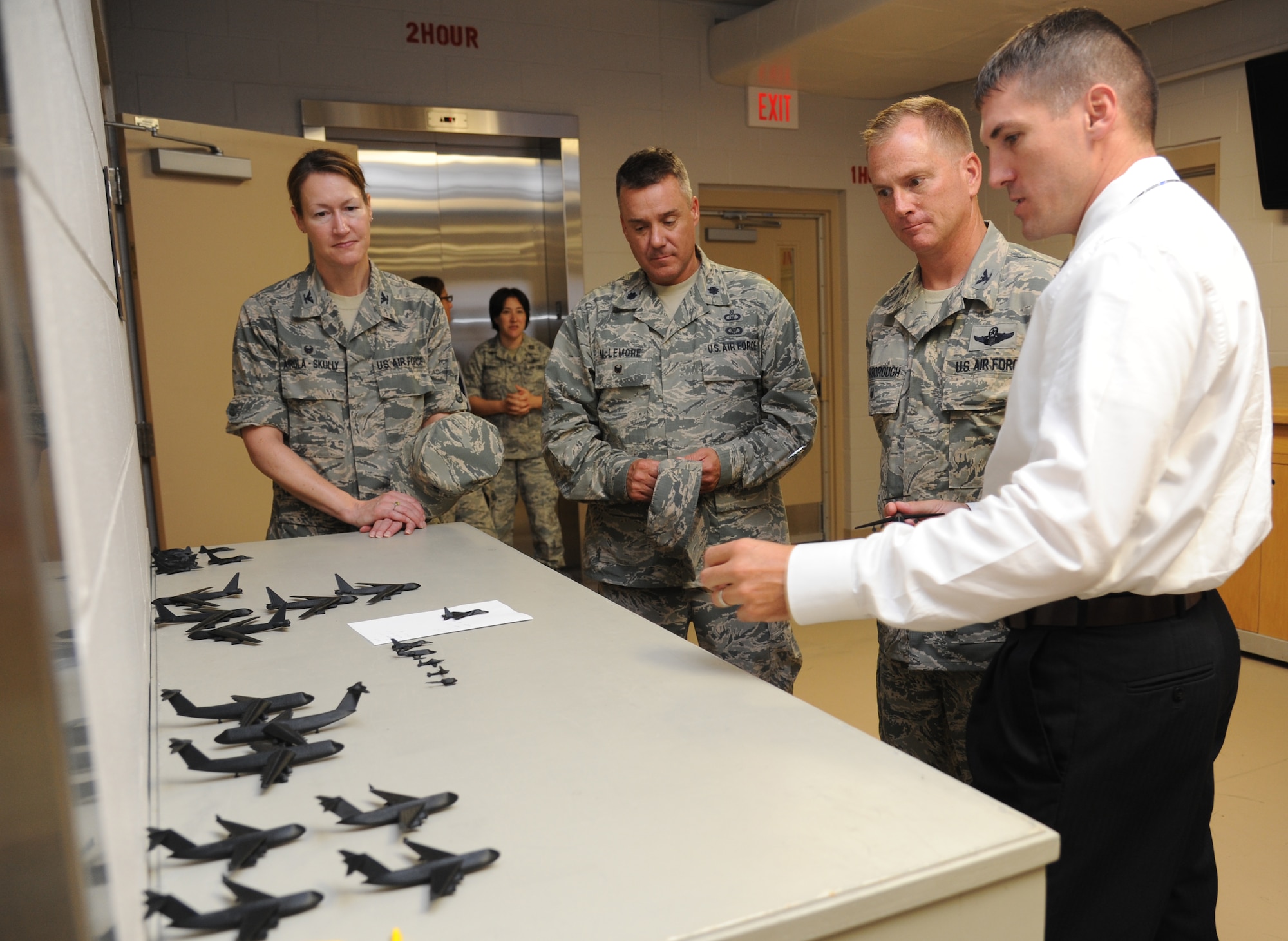 Tomme Lassabe, 81st Training Support Squadron training technology flight chief (right), shows  Col. Susan Airola-Skully, 81st Mission Support Group commander; Lt. Col. Jeffrey McLemore, 81st Training Group deputy director, and Col. Dennis Scarborough, incoming 81st Training Wing vice commander, how 3-D model aircraft are used to help bring realism into the classroom and into base operations during an immersion tour of the 81st Training Group Aug. 8, 2014, at Keesler Air Force Base, Miss.  The purpose of the tour was to learn the integration of the group’s mission, operations and personnel. (U.S. Air Force photo by Kemberly Groue)