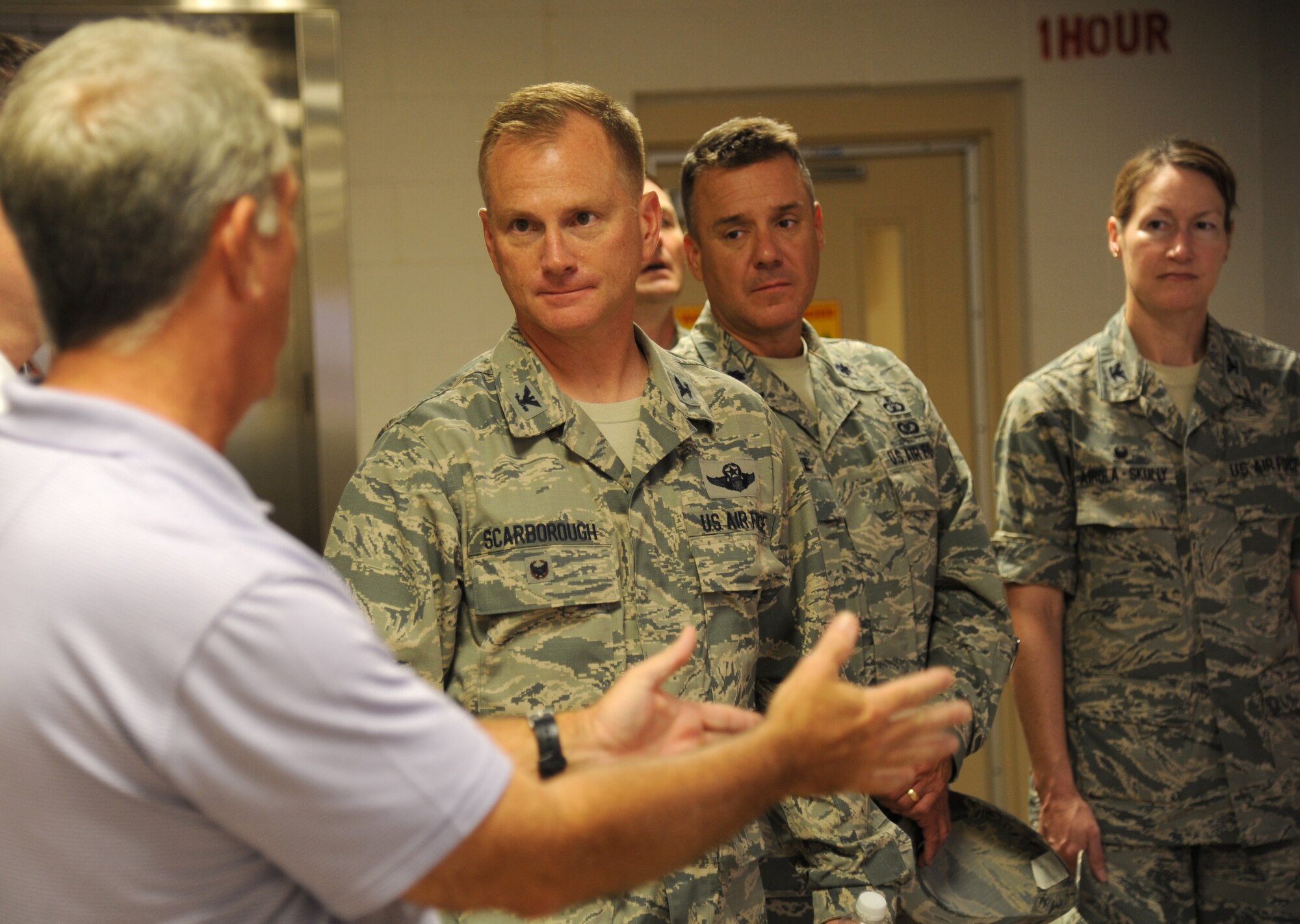 Dave Carley, 81st Training Support Squadron, speaks about the capabilities of the Trainer Development Center with Col. Dennis Scarborough, incoming 81st Training Wing vice commander; Lt. Col. Jeffrey McLemore, 81st Training Group deputy director, and Col. Susan Airola-Skully, 81st Mission Support Group commander, during an immersion tour of the 81st Training Group Aug. 8, 2014, at Keesler Air Force Base, Miss.  The purpose of the tour was to learn the integration of the group’s mission, operations and personnel. (U.S. Air Force photo by Kemberly Groue)
