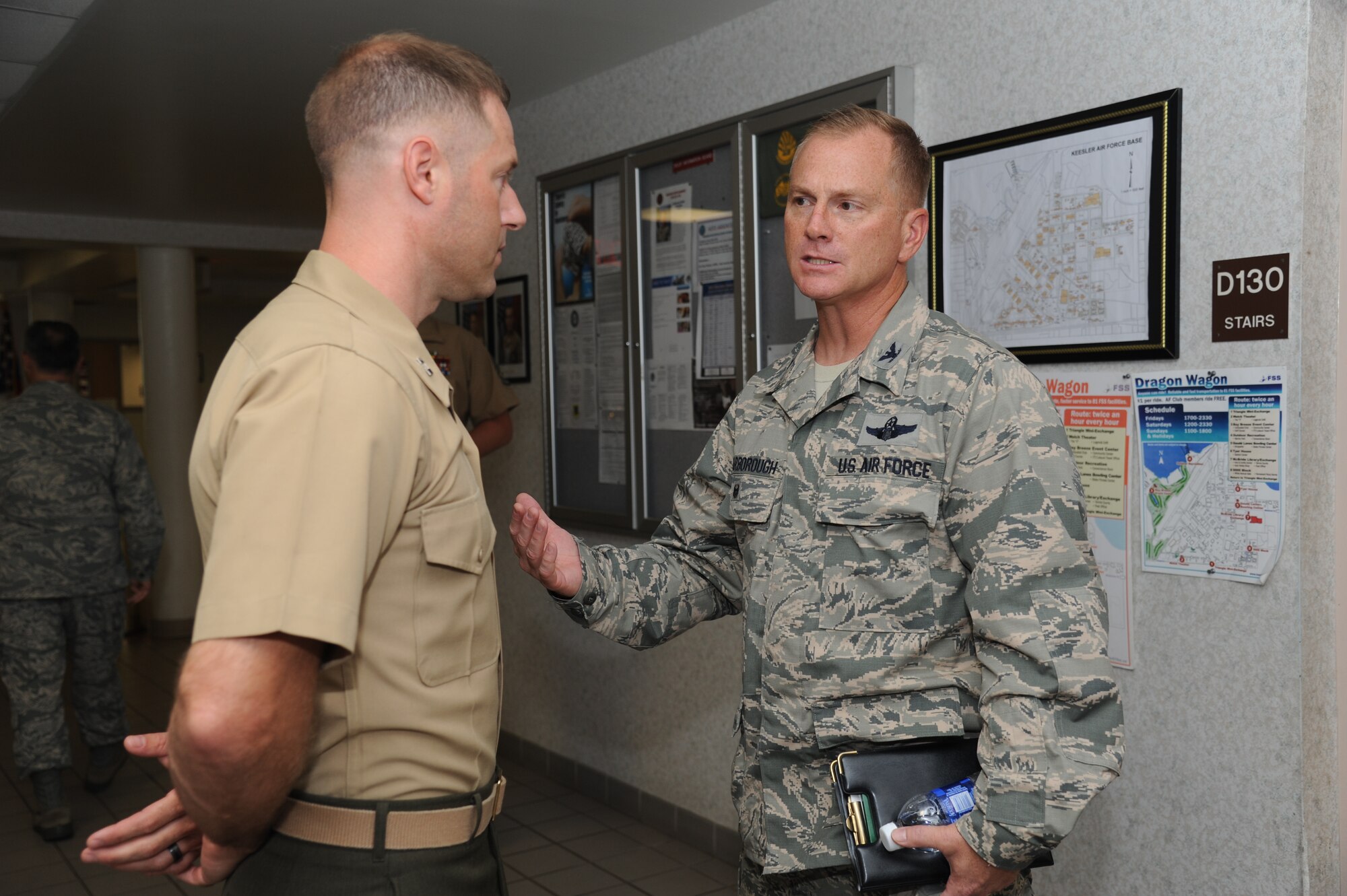 Col. Dennis Scarborough, incoming 81st Training Wing vice commander, speaks with Marine Capt. Gary Baxter, Keesler Marine Detachment commander, while visiting Alho Manor during an immersion tour of the 81st Training Group Aug. 8, 2014, at Keesler Air Force Base, Miss.  The purpose of the tour was to learn the integration of the group’s mission, operations and personnel. (U.S. Air Force photo by Kemberly Groue)
