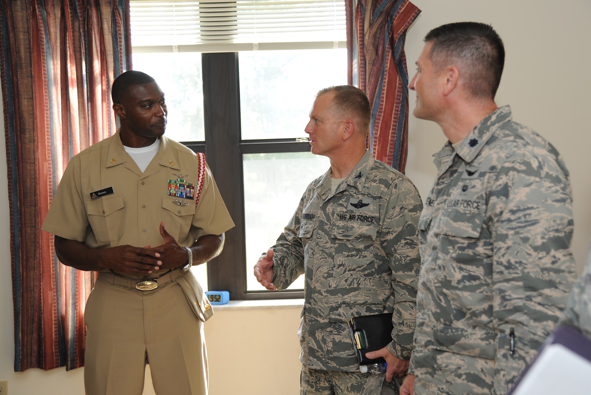 Navy Chief Petty Officer Patrick Massey, Center for Naval Aviation Technical Training Unit Keesler, provides a tour of Alho Manor to Col. Dennis Scarborough, incoming 81st Training Wing vice commander, and Lt. Col. Troy Heavener, 81st TRW judge advocate, during an immersion tour of the 81st Training Group Aug. 8, 2014, at Keesler Air Force Base, Miss.  The purpose of the tour was to learn the integration of the group’s mission, operations and personnel. (U.S. Air Force photo by Kemberly Groue)