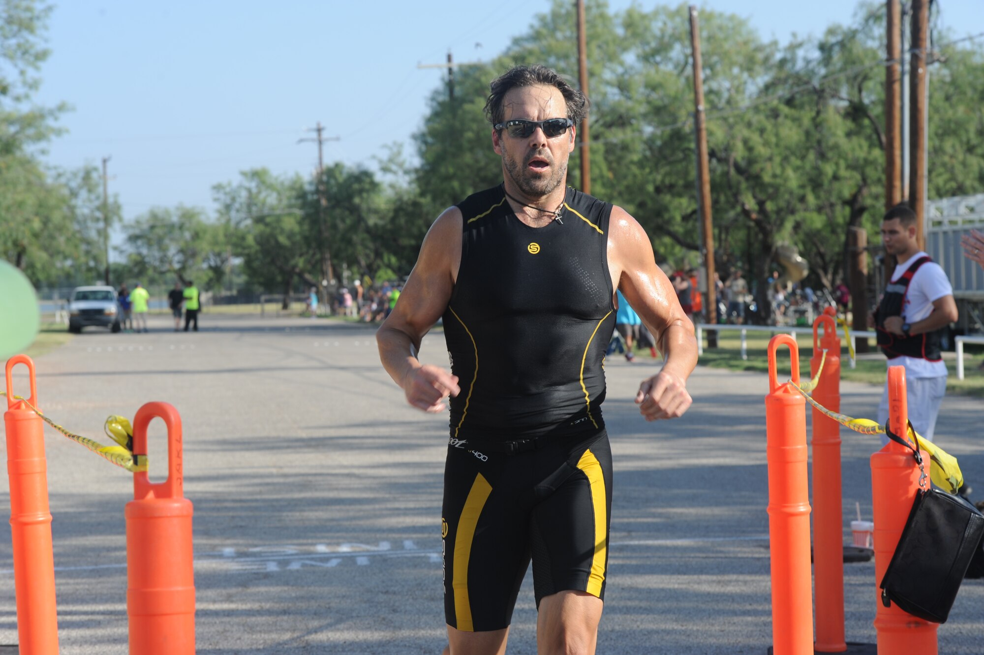 GOODFELLOW AIR FORCE BASE, Texas -- Shane K. Plymell, Shannon Medical Center chief financial officer, finishes first during the 2014 Annual Triathlon at the Goodfellow Recreation Camp July 26. Plymell won top male with a completion time of 1:02:00. (U.S. Air Force photo/ Staff Sgt. Laura R. McFarlane)