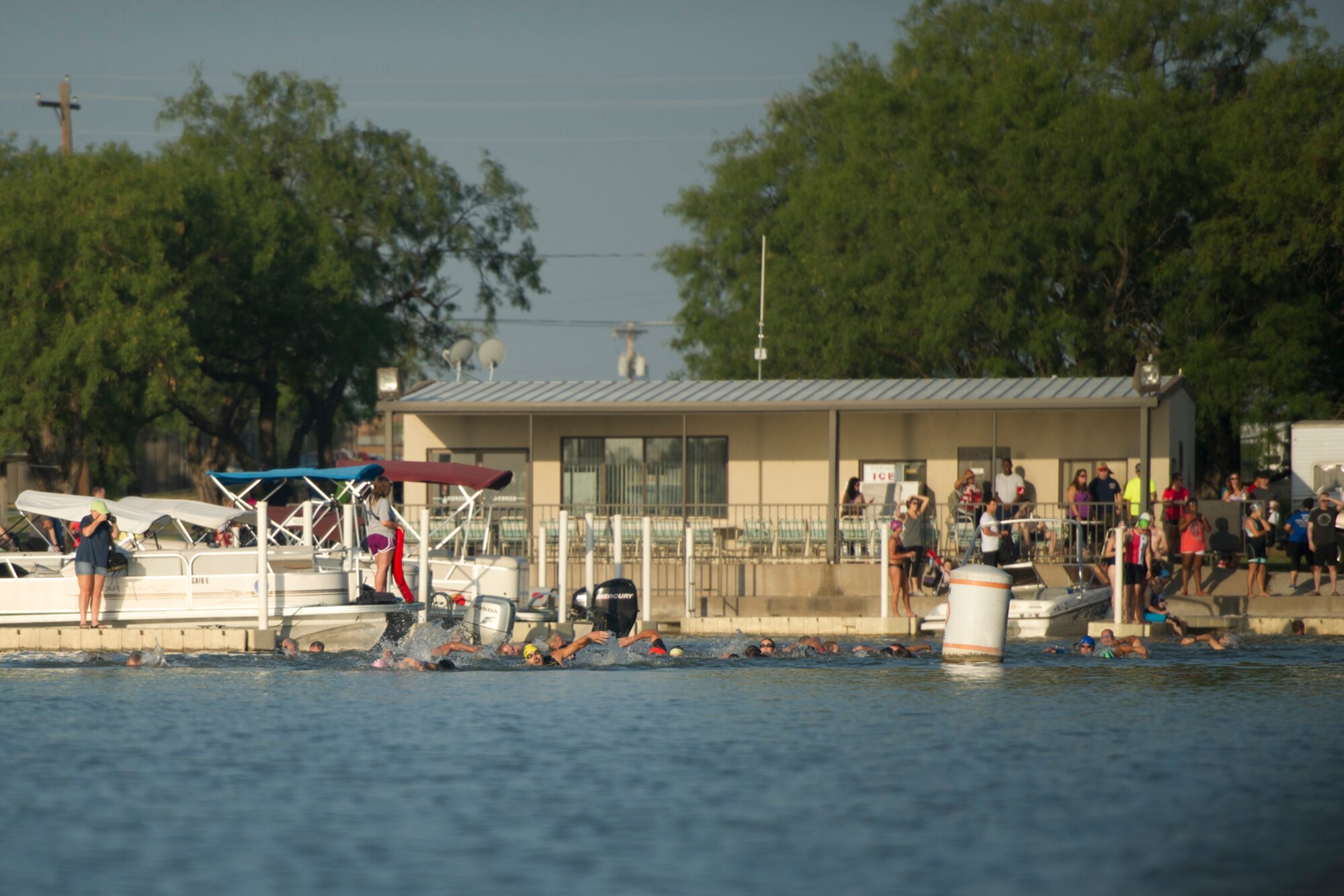 GOODFELLOW AIR FORCE BASE, Texas -- The first group of swimmers begin the race during the 2014 Annual Triathlon at the Goodfellow Recreation Camp July 26. The 400-meter open water swim in Lake Nasworthy was the first portion of the triathlon. (U.S. Air Force photo/ Staff Sgt. Laura R. McFarlane)