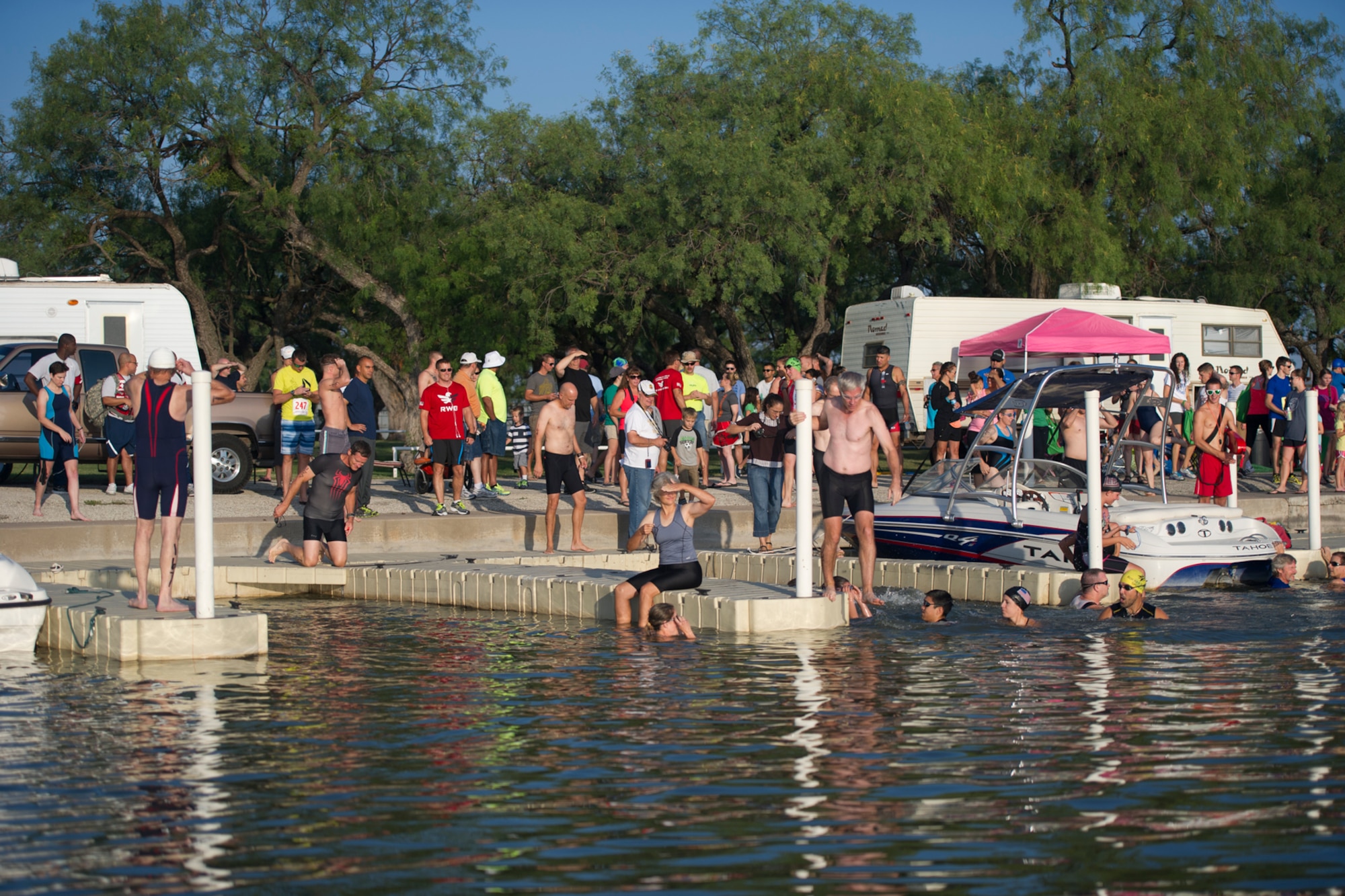 GOODFELLOW AIR FORCE BASE, Texas – Triathletes from San Angelo and Goodfellow prepare for the first swimming heat of the 2014 Annual Triathlon at the Goodfellow Recreation Camp July 26. The event consisted of a 400-meter open water swim in Lake Nasworthy, a 20-kilometer bicycle ride down Knickerbocker Road and a 5-kilometer run on South Concho Drive. (U.S. Air Force photo/ Staff Sgt. Laura R. McFarlane)