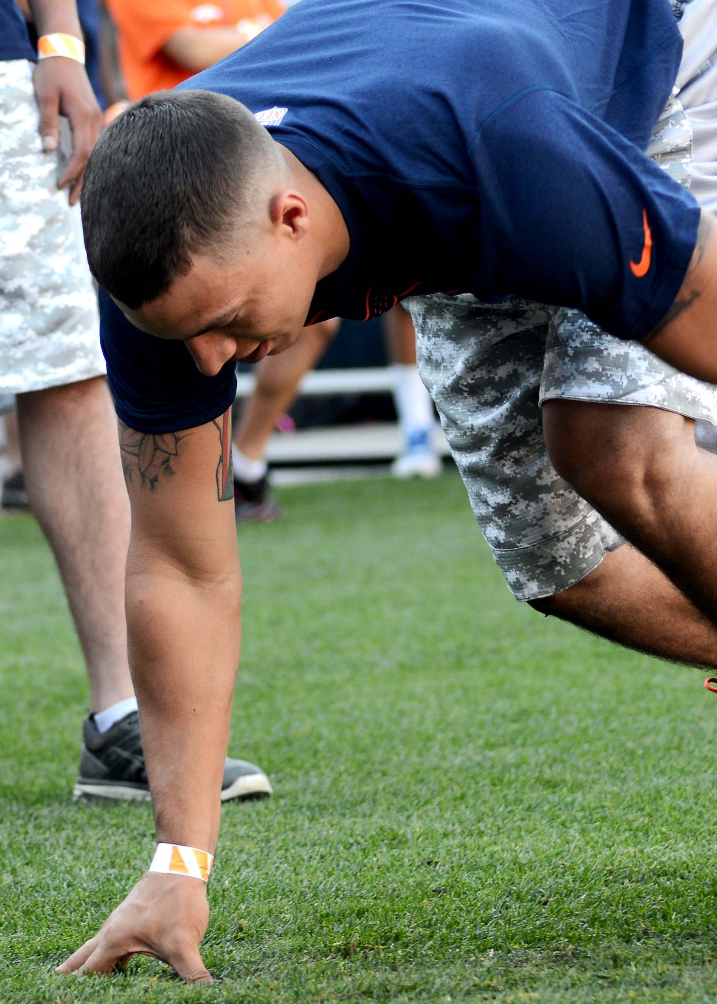 DENVER — Airman 1st Class Aaron Yoe, 21st Force Support Squadron Food Service specialist, crouches as he gets ready to compete in the cone drill at the Denver Broncos Combine at Sports Authority Field at Mile High Aug. 2. The event was sponsored by USAA and the Denver Broncos to support and recognize local military members. (U.S. Air Force photo/Airman 1st Class Rose Gudex)