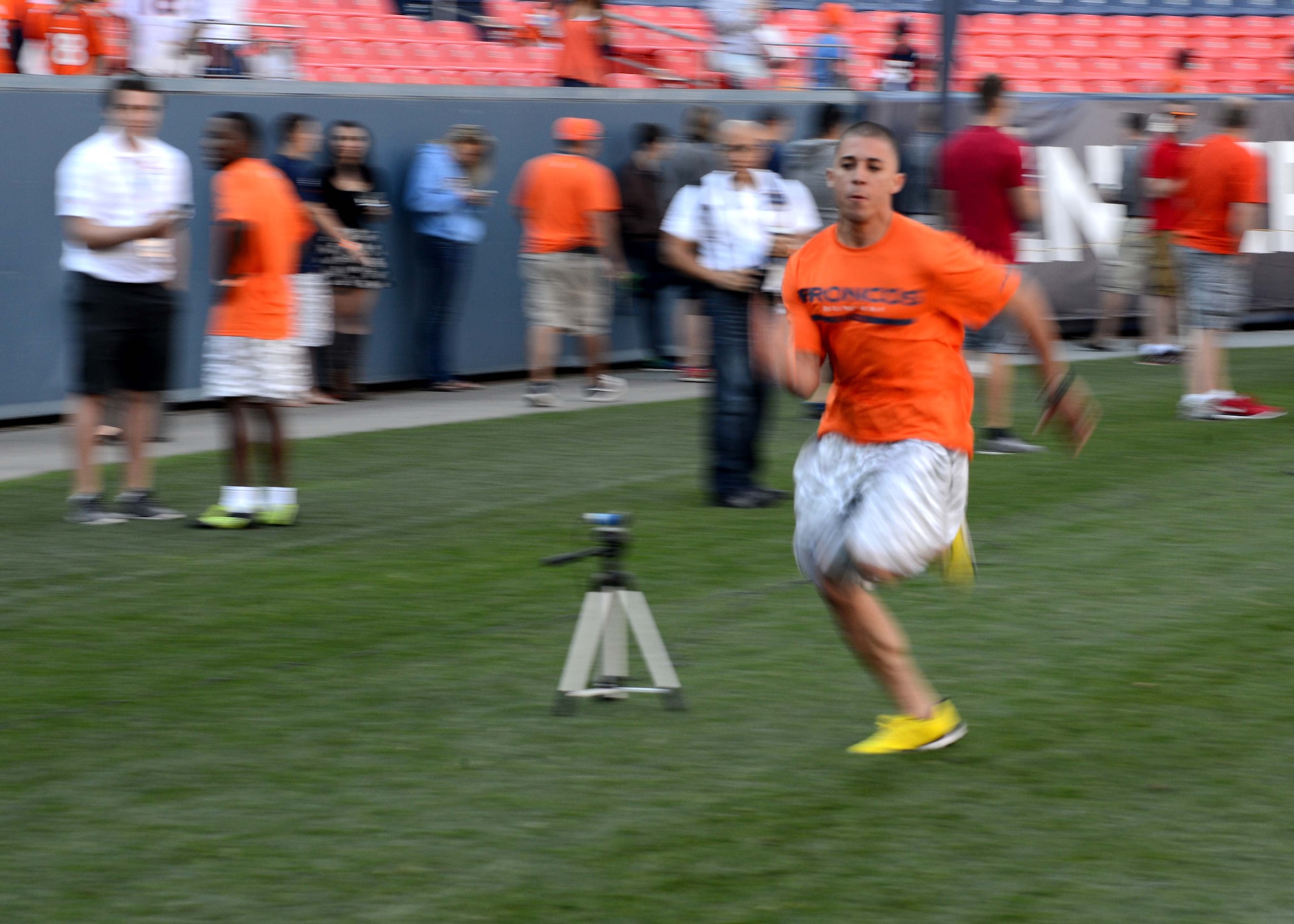 DENVER — Staff Sgt. Luis Hernandez, 21st Space Wing Plans and Programs NCO in charge, sprints the 40 yard dash at the Denver Broncos Combine at Sports Authority Field at Mile High Aug. 2, 2014. Hernandez won the award for the fastest male to complete the 40-yard dash. The event was sponsored by USAA and the Denver Broncos to support and recognize local military members. (U.S. Air Force photo by Airman 1st Class Rose Gudex)