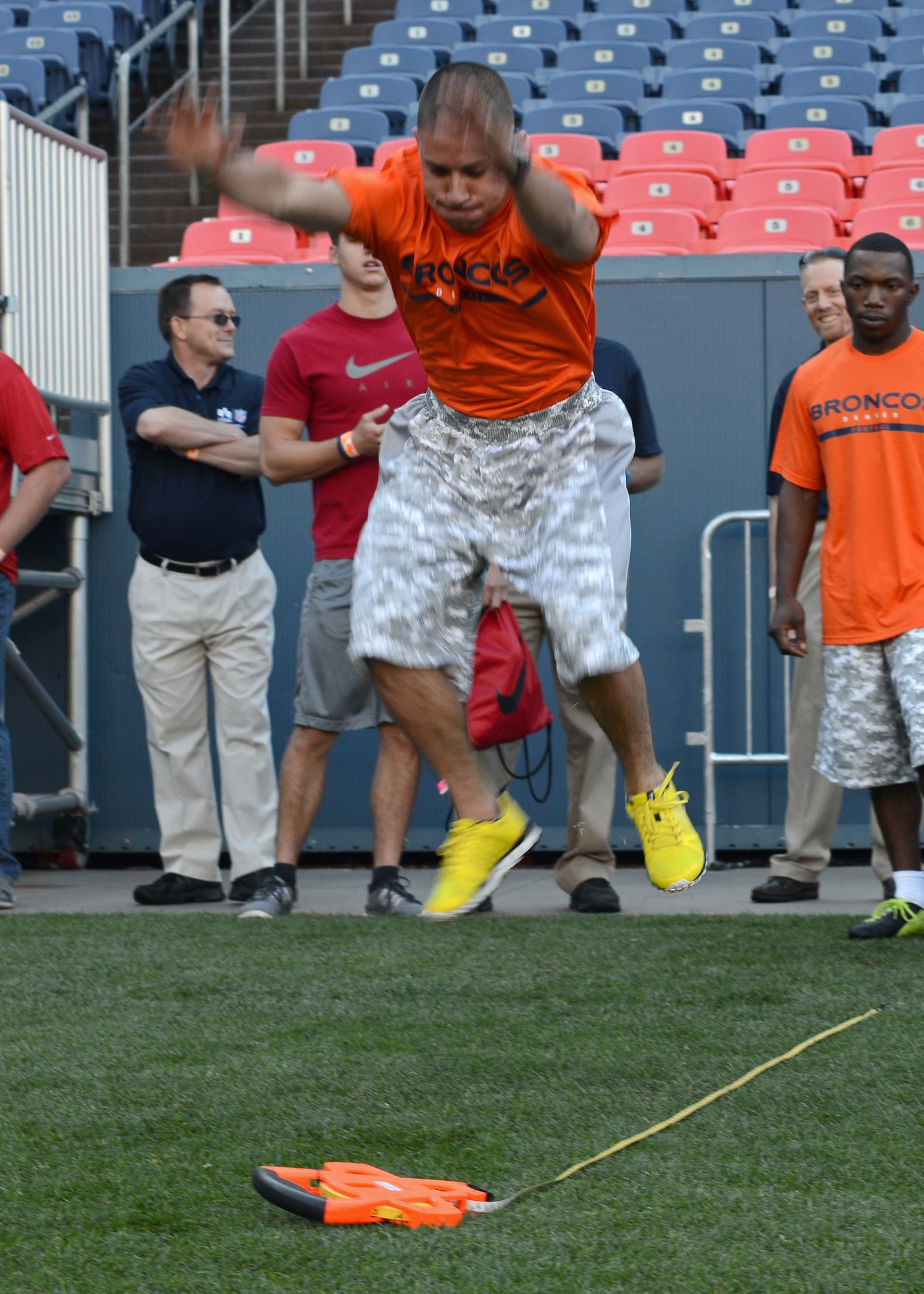 DENVER -- Staff Sgt. Luis Hernandez, 21st Space Wing Plans and Programs NCOIC, leaps in the long jump event at the Denver Broncos Combine at Sports Authority Field at Mile High Aug. 2. The event was sponsored by USAA and the Denver Broncos to support and recognize local military members. (U.S. Air Force photo/Airman 1st Class Rose Gudex)