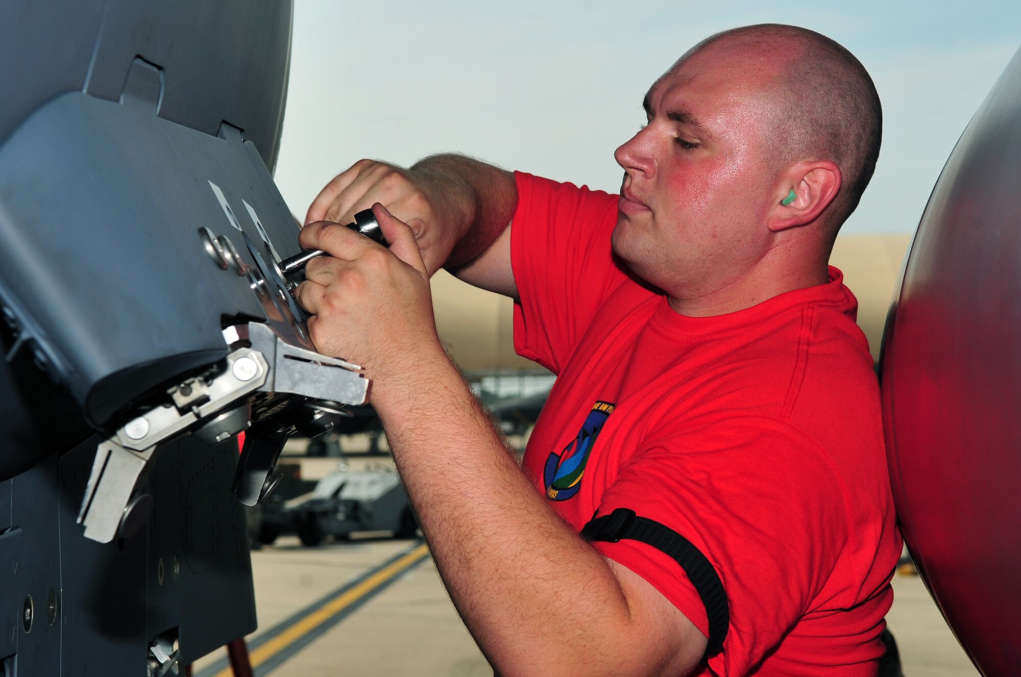 Airman 1st Class Thomas Snyder, 333rd Aircraft Maintanence Unit weapons loadcrew member, prepares a section of the F-15E Strike Eagle to receive ammunition, Aug. 8, 2014, during a loadcrew competition at Seymour Johnson Air Force Base, North Carolina. The quarterly competition showcases a three-man crew from each aircraft maintanence unit. (U.S. Air Force photo/Airman 1st Class Shawna L. Keyes)