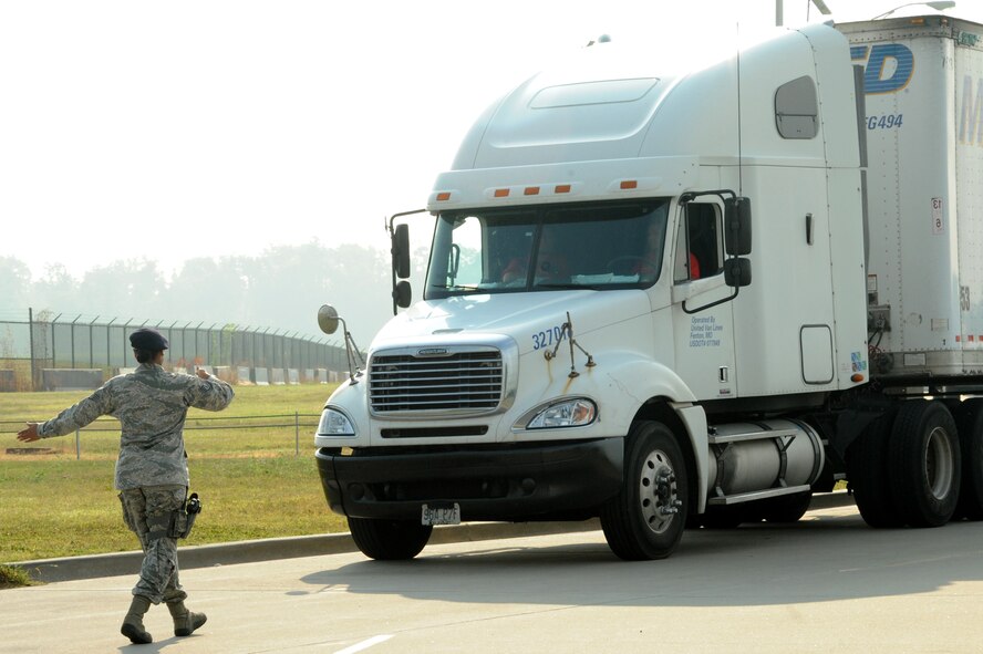 Staff. Sgt. Briana Whittamore, 375 Security Forces installation entry controller, guides a truck on where to park before it gets inspected at the Commercial Vehicle Inspection Station Aug. 6, 2014 at Scott Air Force Base, Illinois. The CVIS can inspect up to roughly 3,000 vehicles a month, making sure contraband or any illegal substance stays off the installation. (U.S. Air Force photo/ Senior Airman Tristin English) 