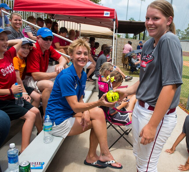 U.S. Air Force Col. Andra Kniep, 23d Wing vice commander, left, and Robin Rudd, Lowndes High School Vikettes softball outfielder, pose for a photo at Morris-Coats Field of Dreams, Valdosta, Ga.,  Aug. 9, 2014. The Vikettes softball team and coaches signed a ball and presented it to Kniep as a token of their appreciation. (U.S. Air Force photo by Airman 1st Class Ceaira Tinsley/Released)
