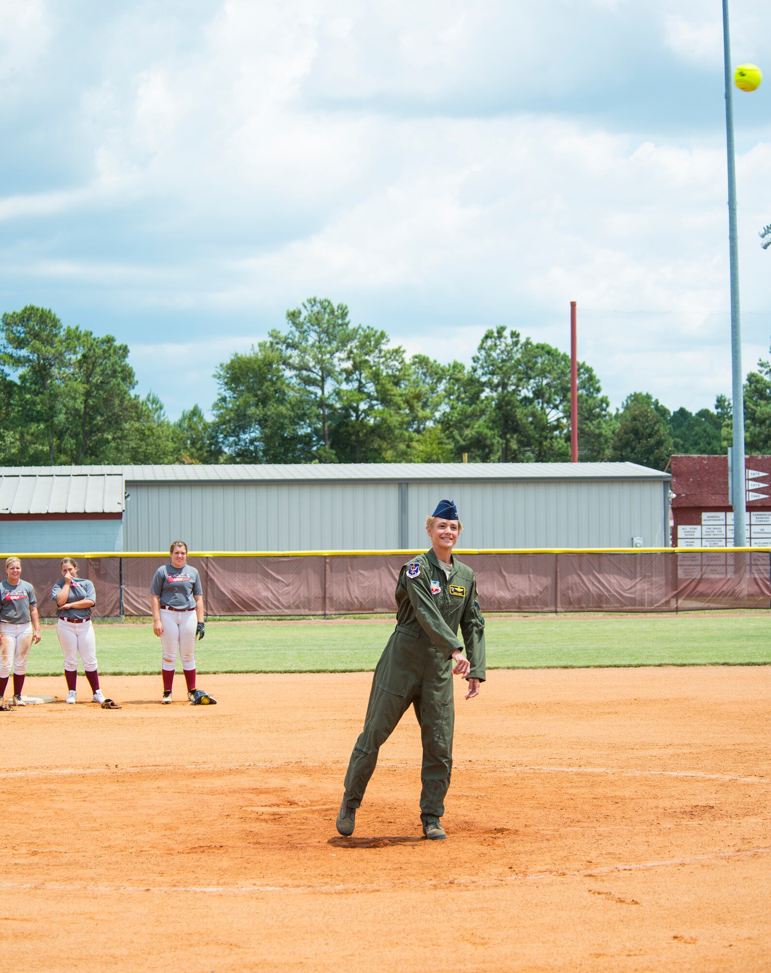 U.S. Air Force Col. Andra Kniep, 23d Wing vice commander, throws a softball to Becca Prairie, Lowndes High School Vikettes softball catcher, at Morris-Coats Field of Dreams, Valdosta, Ga.,  Aug. 9, 2014. Kniep threw the first pitch to start off the Military Appreciation Day game between Lowndes High School Vikettes and Camden High School Wildcats. The Vikettes gave military members a free meal voucher and at the end of each inning, the school asked military members to stand and be recognized for their service. (U.S. Air Force photo by Airman 1st Class Ceaira Tinsley/Released)