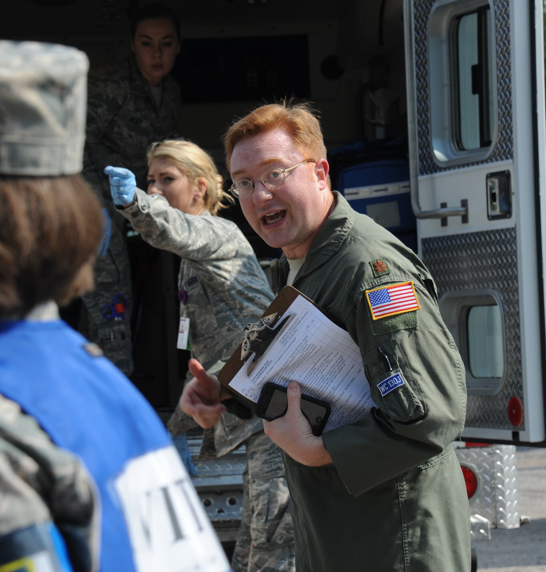 Maj. Shane Steiner, 81st Aerospace Medicine Squadron, communicates with other medical personnel on the transportation of “victims” to the hospital during a major accident response exercise Aug. 7, 2014, at the Locker House at Keesler Air Force Base, Miss. Team Keesler practiced real-world training during the exercise which simulated a gas line explosion that set a building on fire.  (U.S. Air Force photo by Kemberly Groue)