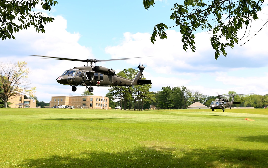 HH-60M medical evacuation helicopters from the 4th Combat Aviation Brigade conduct aerial evacuations at the Muscatatuck Urban Training Center during exercise Vibrant Response 14, July 24, 2014. During the exercise, Joint Task Force Civil Support anticipated, planned and prepared for  chemical, biological, radiological, nuclear defense support to civil authorities response operations. (Department of Defense photo by U.S. Navy Petty Officer 1st Class Brian Dietrick/Released)
