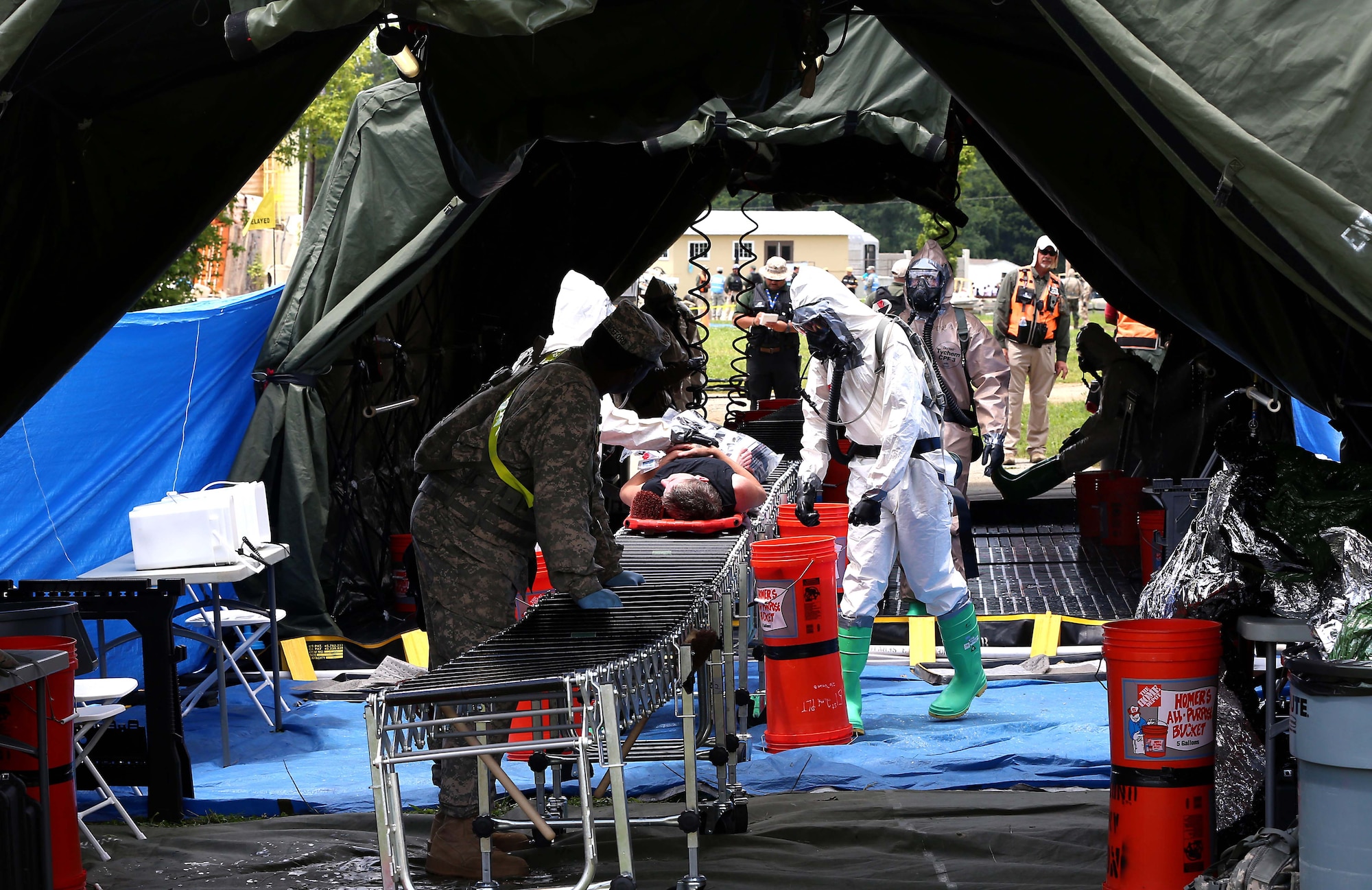 U.S. Army Soldiers from the 83rd Chemical Battalion, from Fort Stewart, Ga., conduct casualty decontamination operations at the Muscatatuck Urban Training Center during exercise Vibrant Response 14, July 24, 2014. Joint Task Force Civil Support and other Department of Defense agencies participated in the largest confirmation exercise for specialized response forces. (Department of Defense photo by U.S. Navy Petty Officer 1st Class Brian Dietrick/Released)