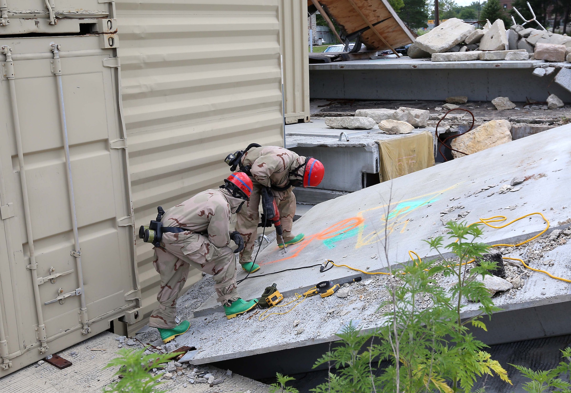 U.S. Army Soldiers from the 83rd Chemical Battalion, from Fort Stewart, Ga., conduct search and rescue operations at the Muscatatuck Urban Training Center during exercise Vibrant Response 14, July 24, 2014. The exercise evaluated the ability of Joint Task Force Civil Support and other Department of Defense forces to respond to multiple catastrophic events in a major metropolitan city involving a chemical, biological, radiological and nuclear incident. (Department of Defense photo by U.S. Navy Petty Officer 1st Class Brian Dietrick/Released)