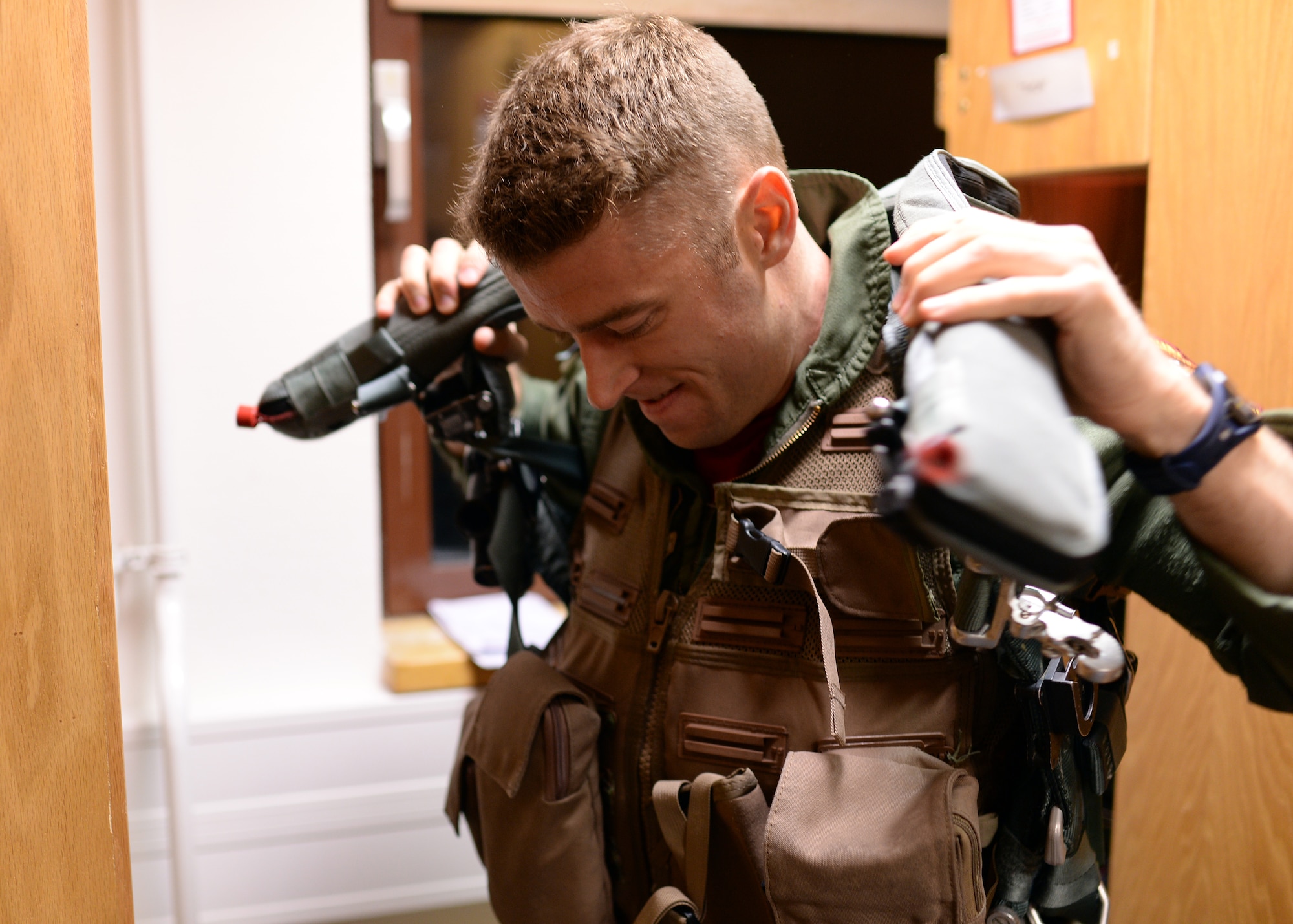 A U.S. Air Force F-16 Fighting Falcon fighter aircraft pilot from the 480th Fighter Squadron at Spangdahlem Air Base, Germany, dons his flight gear Aug. 8, 2014, prior to departing for a bilateral training event to Souda Bay, Greece, Aug. 11-23. Nearly 20 aircraft are participating from Spangdahlem to strengthen the air-to-air compatibility between the U.S. and Greece, with the hopes that such training will lead to regional peace and stability throughout Europe. (U.S. Air Force photo by Staff Sgt. Daryl Knee/Released)
