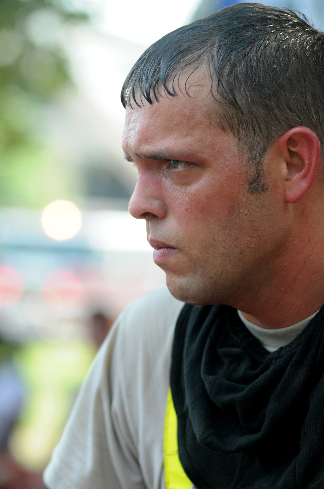 Staff Sgt. Thomas Wallace, 403rd Wing firefighter, looks up while providing medical attention to fire “victims” during a major accident response exercise Aug. 7, 2014, at the Locker House at Keesler Air Force Base, Miss. Team Keesler practiced real-world training during the exercise which simulated a gas line explosion that set a building on fire. Due to the extreme temperatures, exercise “players” wore minimal fire gear. (U.S. Air Force photo by Kemberly Groue)
