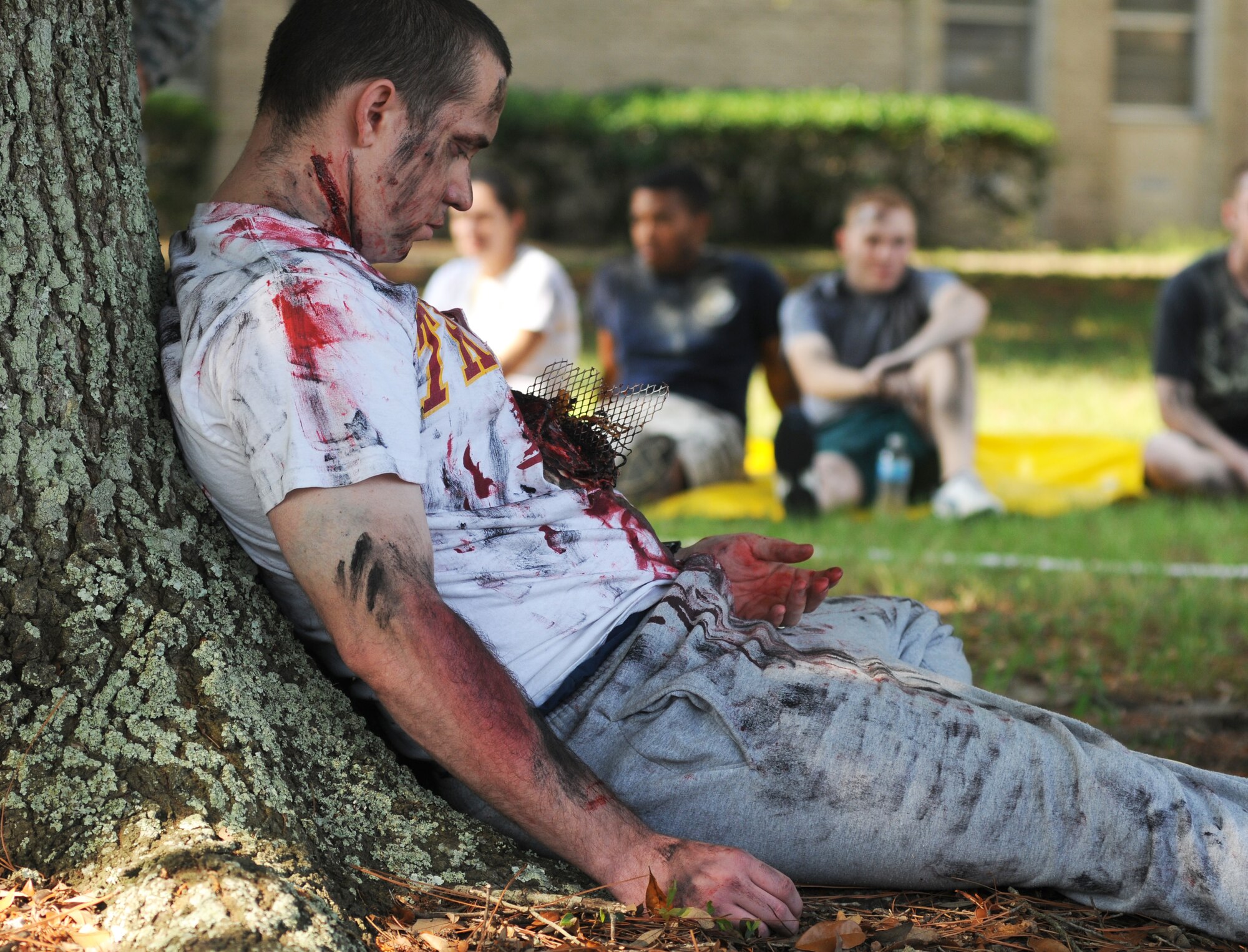 Senior Airman Willie Moore, 81st Logistics Readiness Squadron, portrays a fire “victim” who died during a major accident response exercise Aug. 7, 2014, at the Locker House at Keesler Air Force Base, Miss. Team Keesler practiced real-world training during the exercise which simulated a gas line explosion that set a building on fire. (U.S. Air Force photo by Kemberly Groue)
