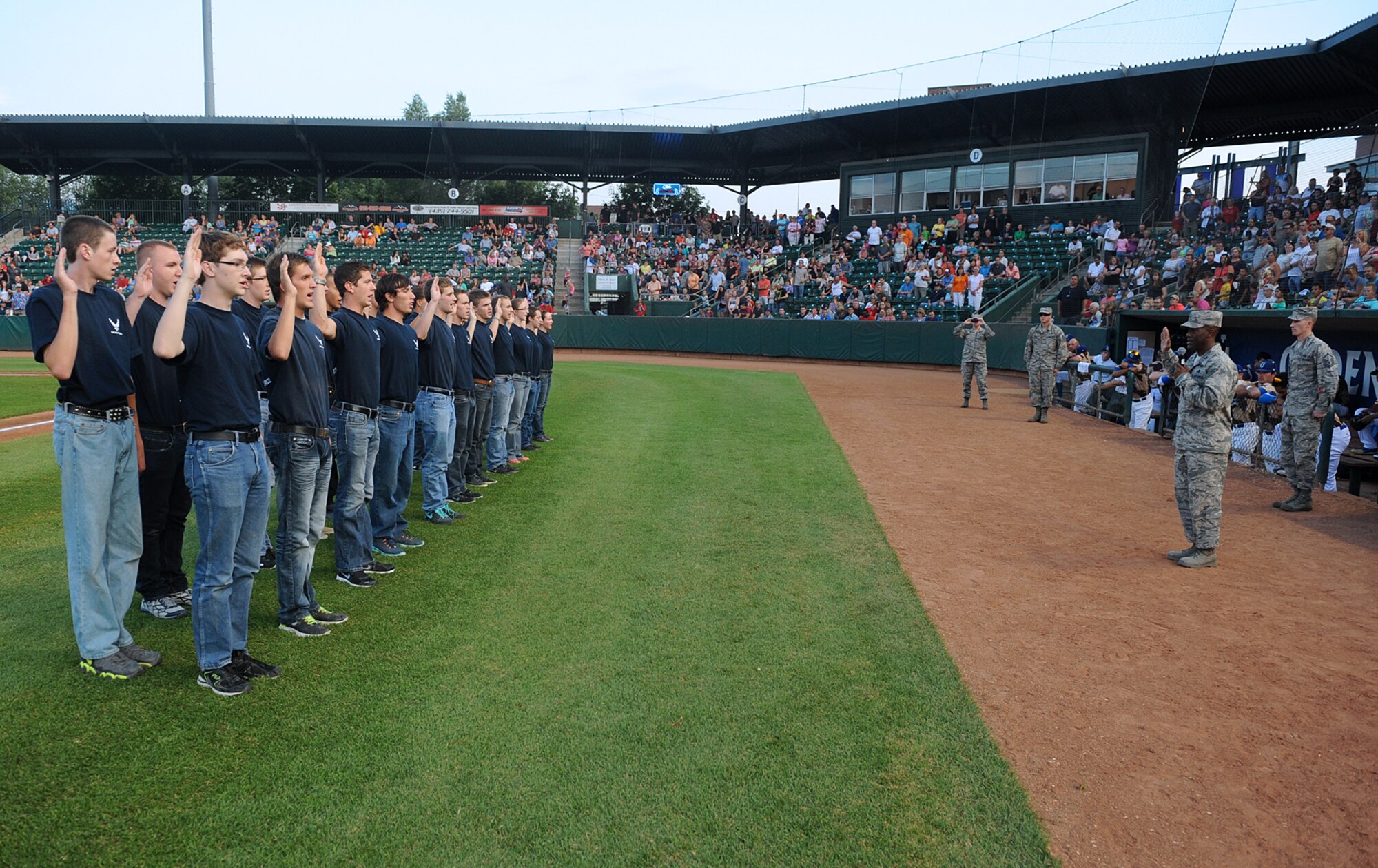 Twenty-one of the U.S. Air Force's newest recruits were sworn in Friday by Col. Ron Jolly, 75th Air Base Wing and Installation commander, during the Ogden Raptors' Military Appreciation Night game. (U.S. Air Force photo by Alex R. Lloyd)