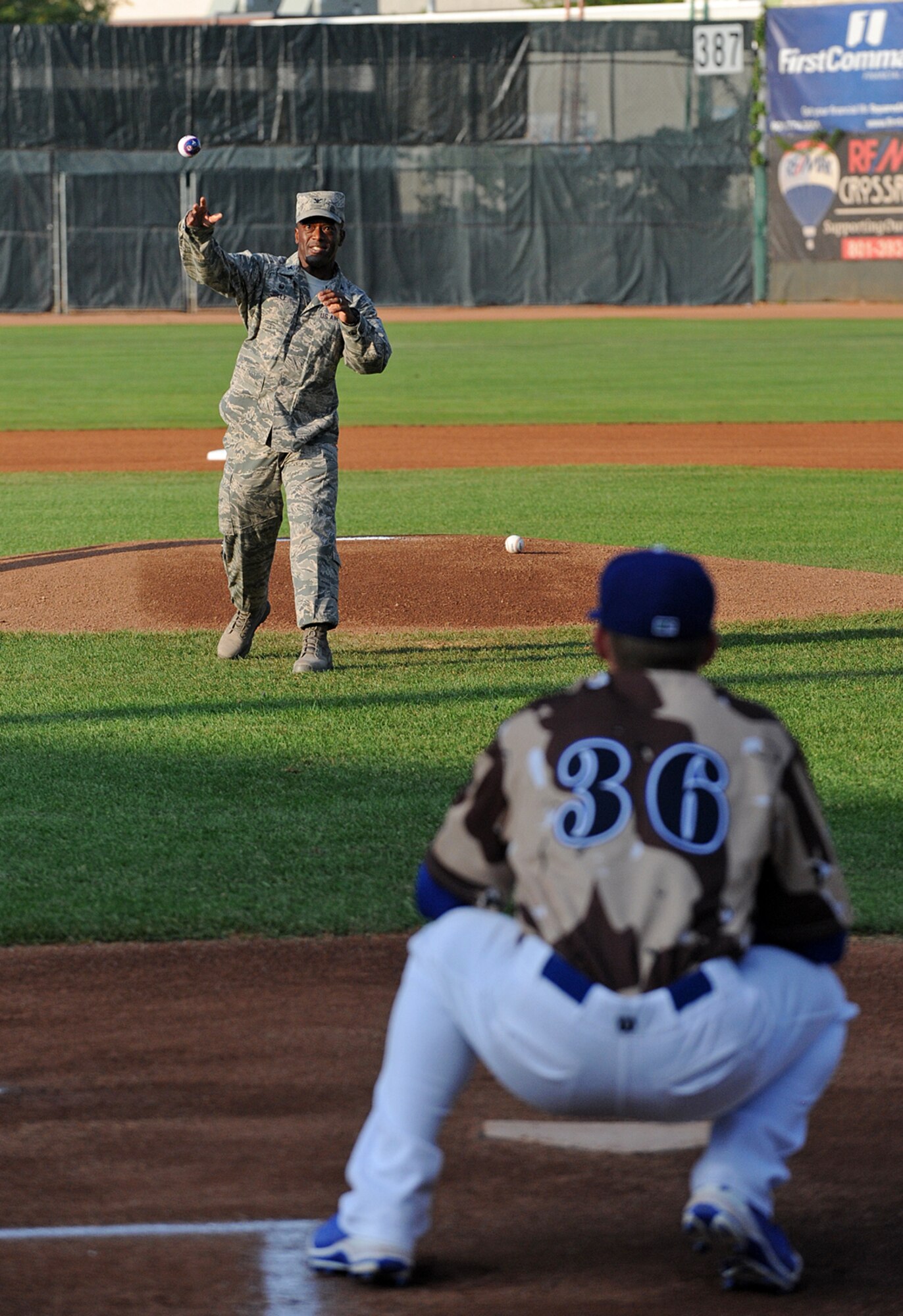 Col. Ron Jolly, 75th Air Base Wing and Installation commander, throws the first pitch Friday at the Ogden Raptors' Military Appreciation Night game. The Raptors wore brown and tan camouflage uniforms in honor of our nation's military members. (U.S. Air Force photo by Alex R. Lloyd)