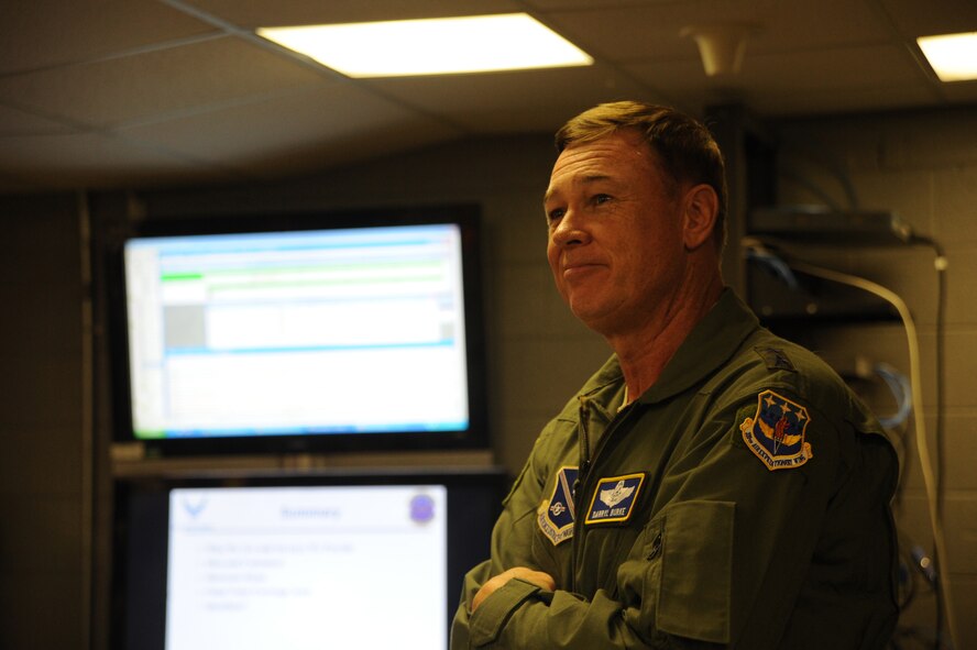 Air Force District of Washington Commander Maj. Gen. Darryl Burke listens to a briefing by Airman 1st Class Michael Murphy about radio frequency transmission systems during the general’s visit to the 844th Communications Group at Joint Base Andrews, Maryland, Aug. 8, 2014. Airmen at the radio frequency transmission systems shop are responsible for setting up public address systems for Air Force events across the National Capital Region. They also maintain land mobile radios and provide ground to air communication support for Air Force One. Murphy is a 744th Communications Squadron radio frequency transmission apprentice. (U.S. Air Force photo/Master Sgt. Tammie Moore)