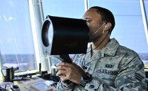 Senior Airman John Porter, 2nd Operations Support Squadron air traffic control operator, demonstrates how to use a light gun on Barksdale Air Force Base, La., Aug. 8, 2014. The light gun is most often used when radio communication is difficult between the traffic control tower and the aircraft. (U.S. Air Force photo/Airman 1st Class Benjamin Raughton)