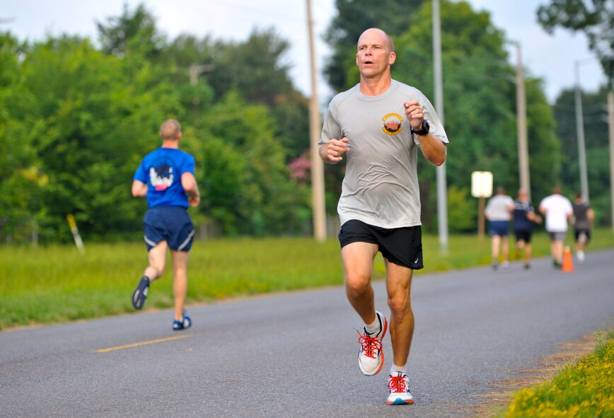 Col. Aaron Ullman, Eighth Air Force standards and evaluations director, crosses the finish line of the Superhero 5K Fun Run on Barksdale Air Force Base, La., Aug. 8, 2014. Ullman finished in 1st place with a time of 19:58. (U.S. Air Force photo/Airman 1st Class Benjamin Raughton)