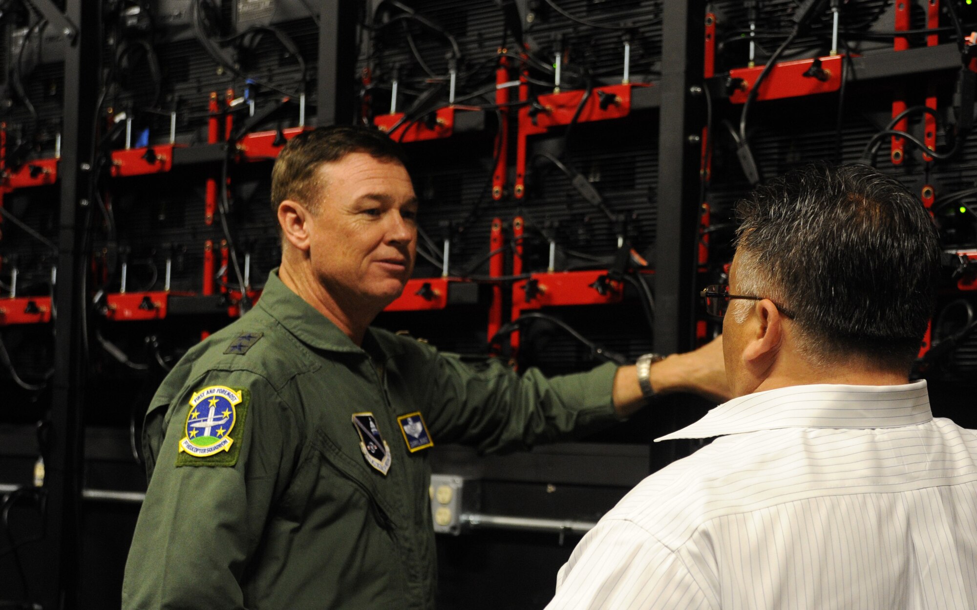 George Etrata explains the Christie digital tile wall to the Air Force District of Washington Commander Maj. Gen. Darryl Burke during the general’s visit to the Gen. Jacob E. Smart Building at Joint Base Andrews, Maryland, Aug. 8, 2014. The Smart Building is used to host strategic and transformational planning sessions which allows national leadership to assemble in a single location to examine and develop doctrine, strategy and policy. Etrata is a multimedia specialist at the Smart Building. (U.S. Air Force photo/Master Sgt. Tammie Moore)