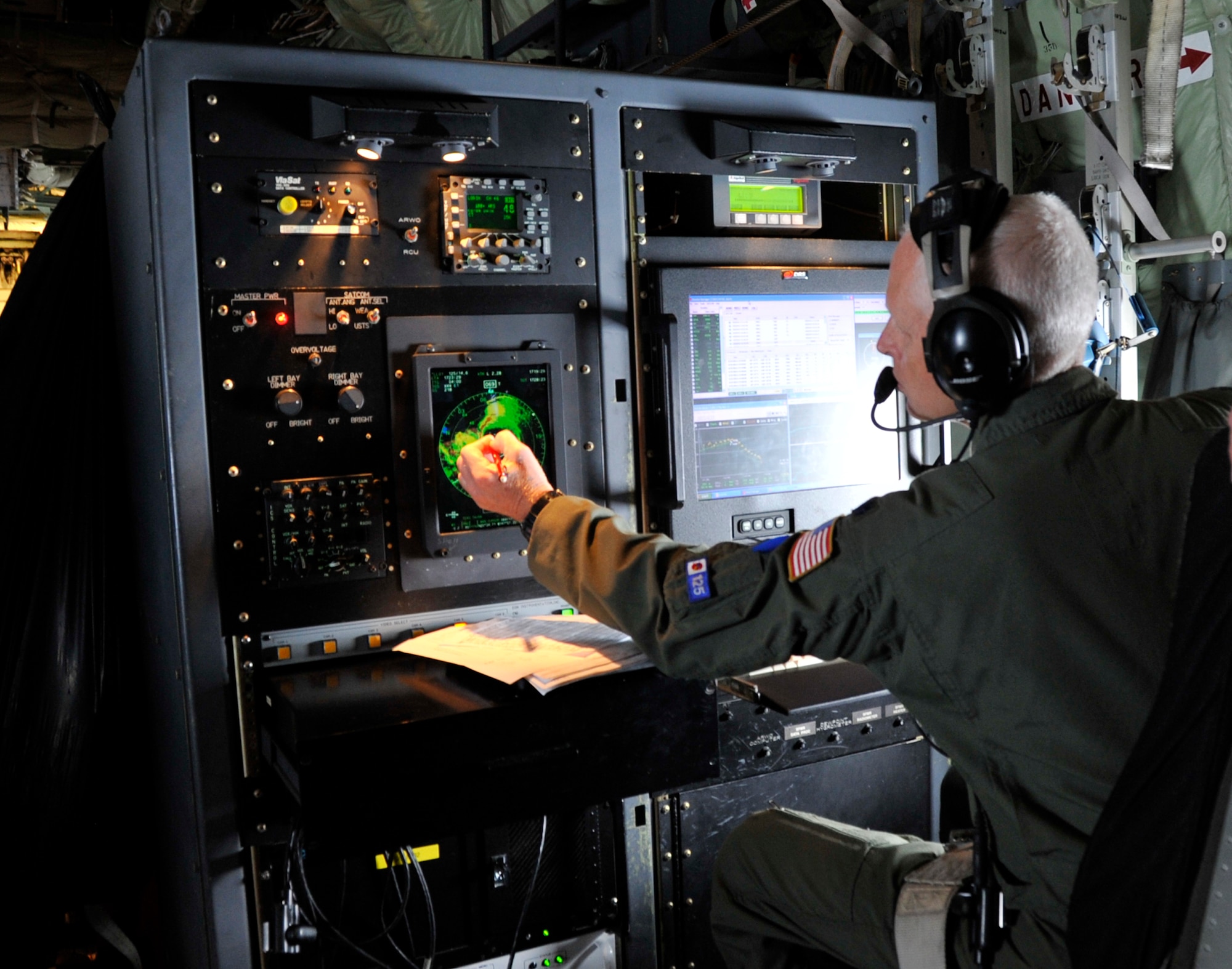 Lt. Col. Jon Talbot, 53rd Weather Reconnaissance Squadron aerial reconnaissance weather officer, points to the eye of Hurricane Julio during a hurricane flight off the coast of Hawaii Aug. 9, 2014. The 53rd WRS "Hurricane Hunters" aircrew and 403rd Wing maintenance personnel deployed to Joint Base Pearl Harbor-Hickam, Hawaii, to fly storm missions into Hurricanes Iselle and Julio.  The "Hurricane Hunters" fly storm missions in both the Atlantic and Pacific Oceans during the hurricane season June 1 to Nov. 30 yearly. (U.S. Air Force photo by Master Sgt. Jessica Kendziorek)  