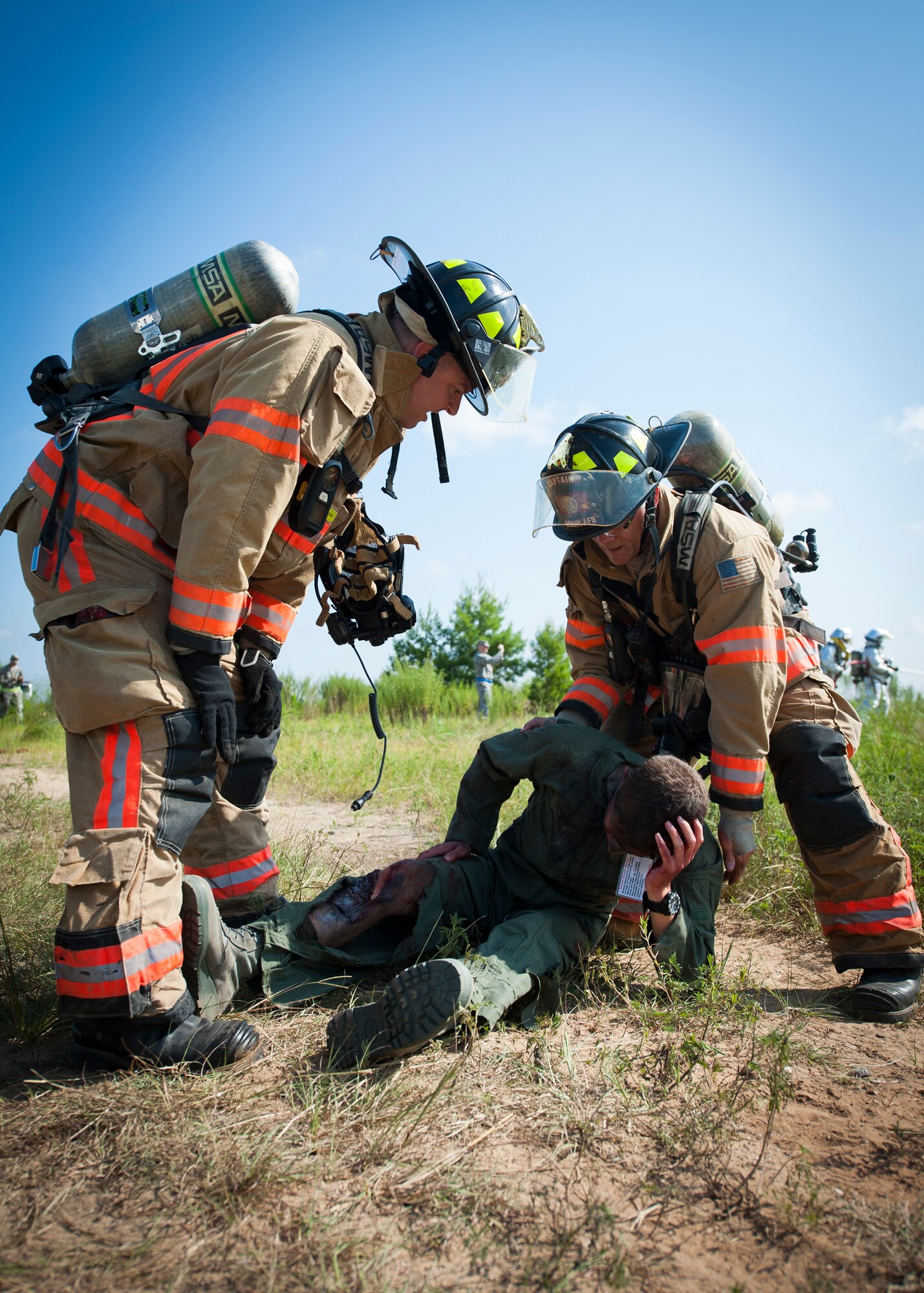 Eglin Air Force Base firefighters prepare to move a simulated victim during a major accident response exercise Aug. 6 at Duke Field.  Emergency responders from the base and the city were called to a downed aircraft scenario featuring fire, wreckage and victims with multiple injuries. The responders had to work as a team and coordinate movements at the simulated crash site, put out fires and attend to the wounded victims. (U.S. Air Force photo/Tech. Sgt. Jasmin Taylor)