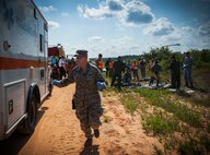 A 96th Medical Group Airman moves with urgency during a major accident response exercise Aug. 6 at Duke Field. The simulated accident was a mid-air collision of a 33rd Fighter Wing joint strike fighter and a 919th Special Operations Wing C-145.  Emergency responders from the base and the city were called to a downed aircraft scenario featuring fire, wreckage and victims with multiple injuries. The responders had to work as a team and coordinate movements at the simulated crash site, put out fires and attend to the wounded victims. (U.S. Air Force photo/Tech. Sgt. Jasmin Taylor)